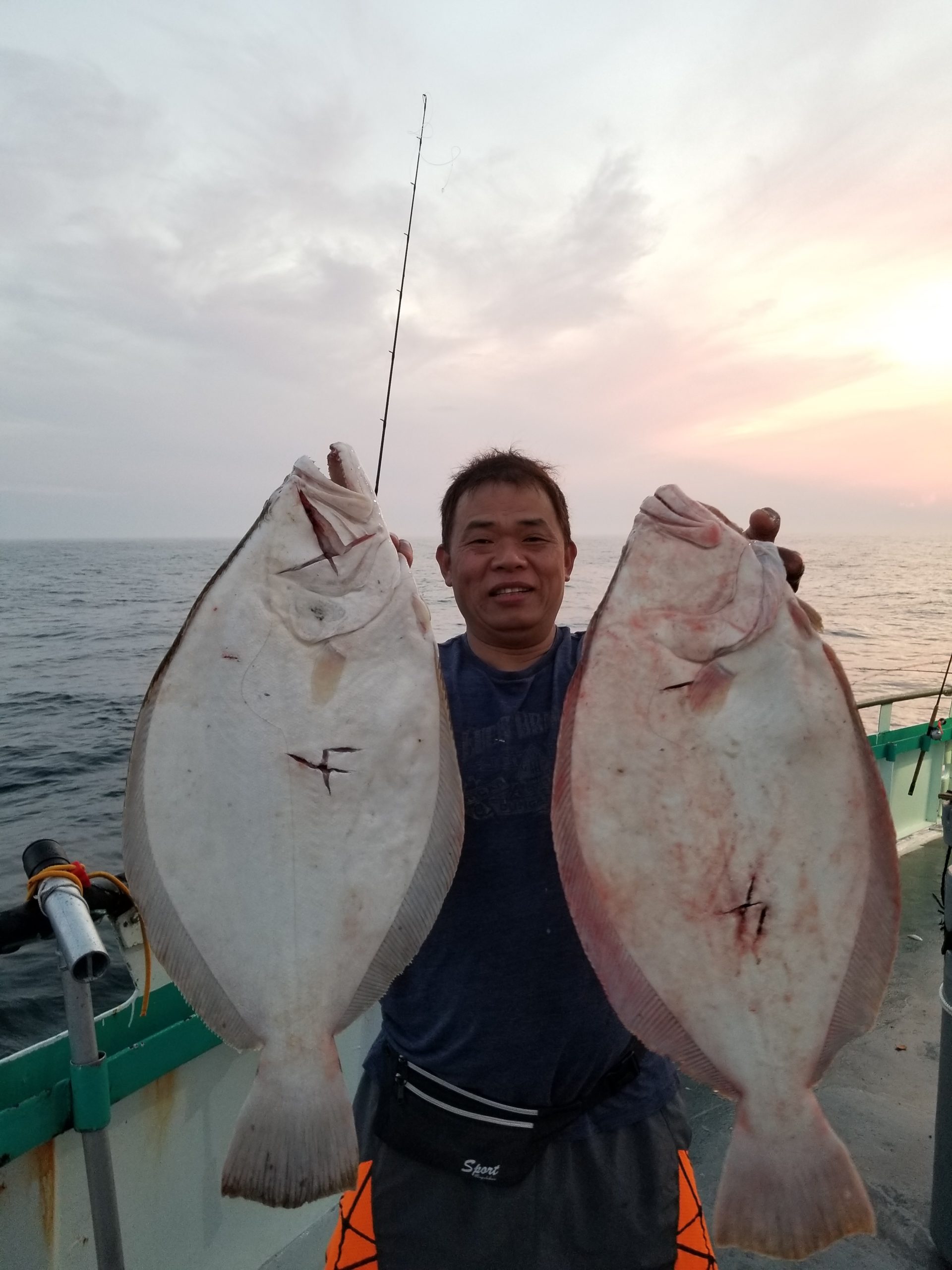 a person holding a fish in the water