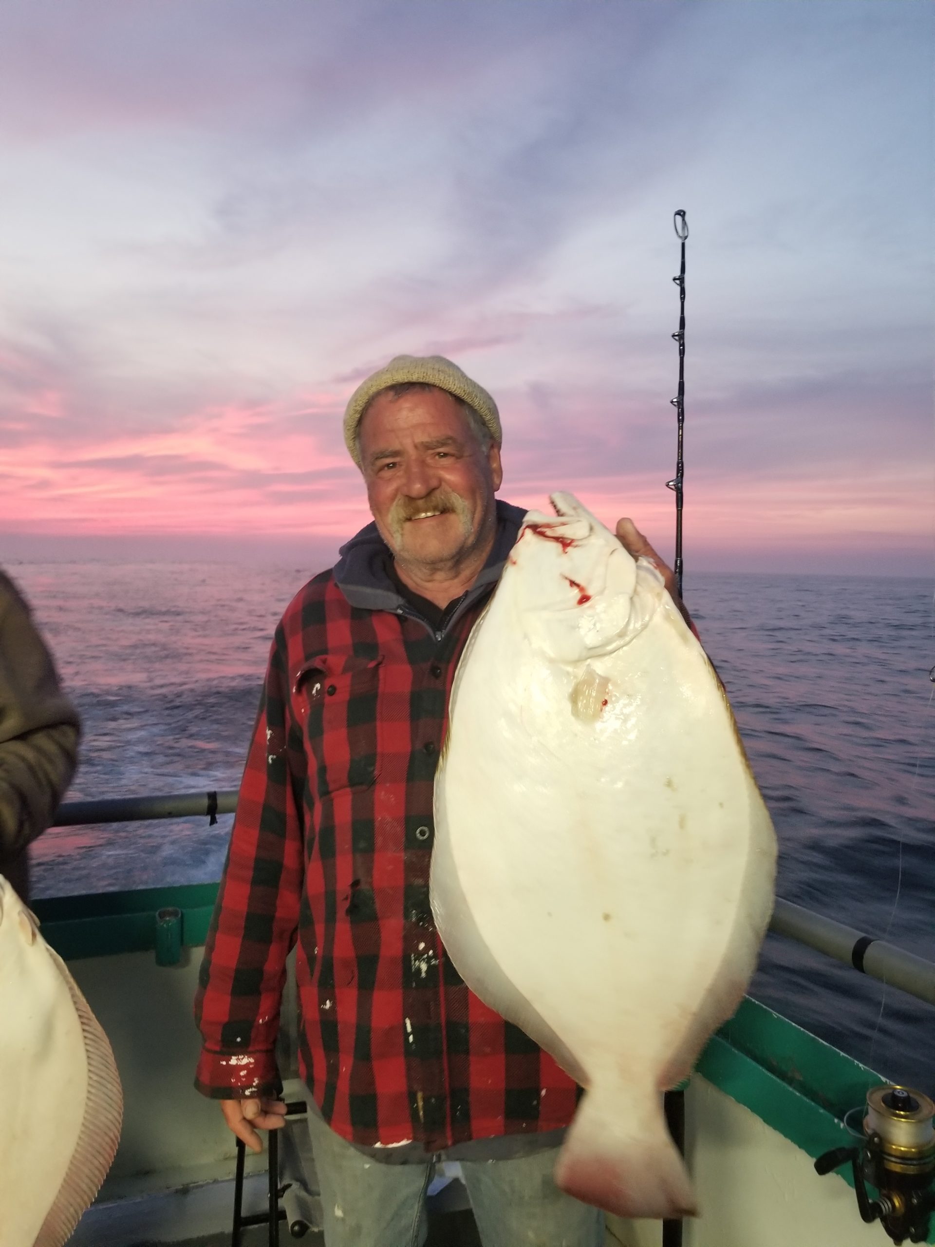a person holding a fish in the water
