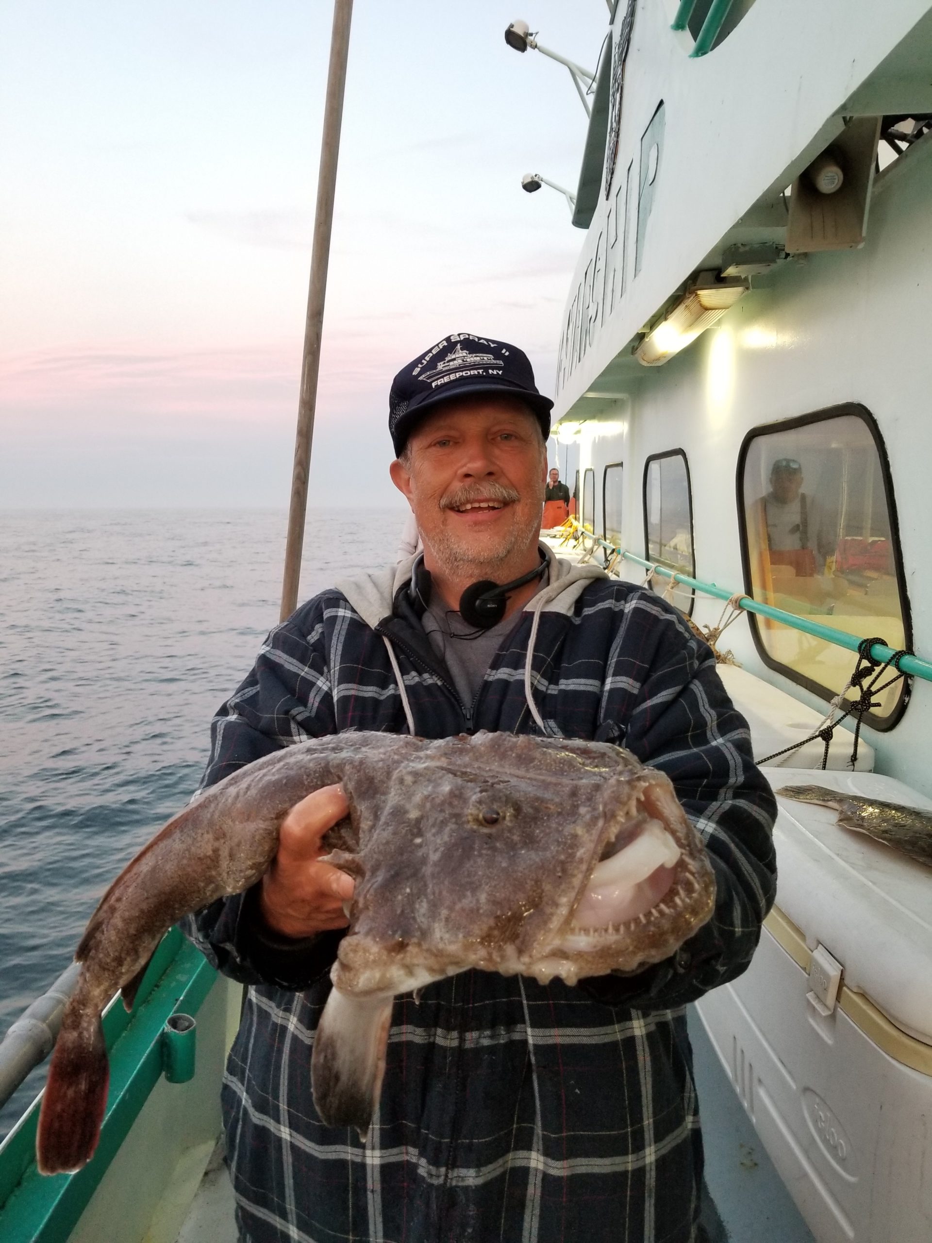 a man holding a fish in the water