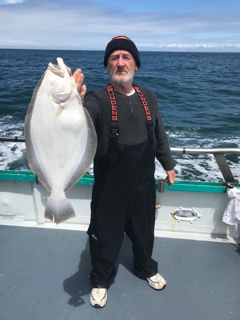a man holding a fish in the water