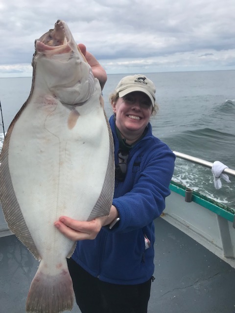 a person holding a fish in the water