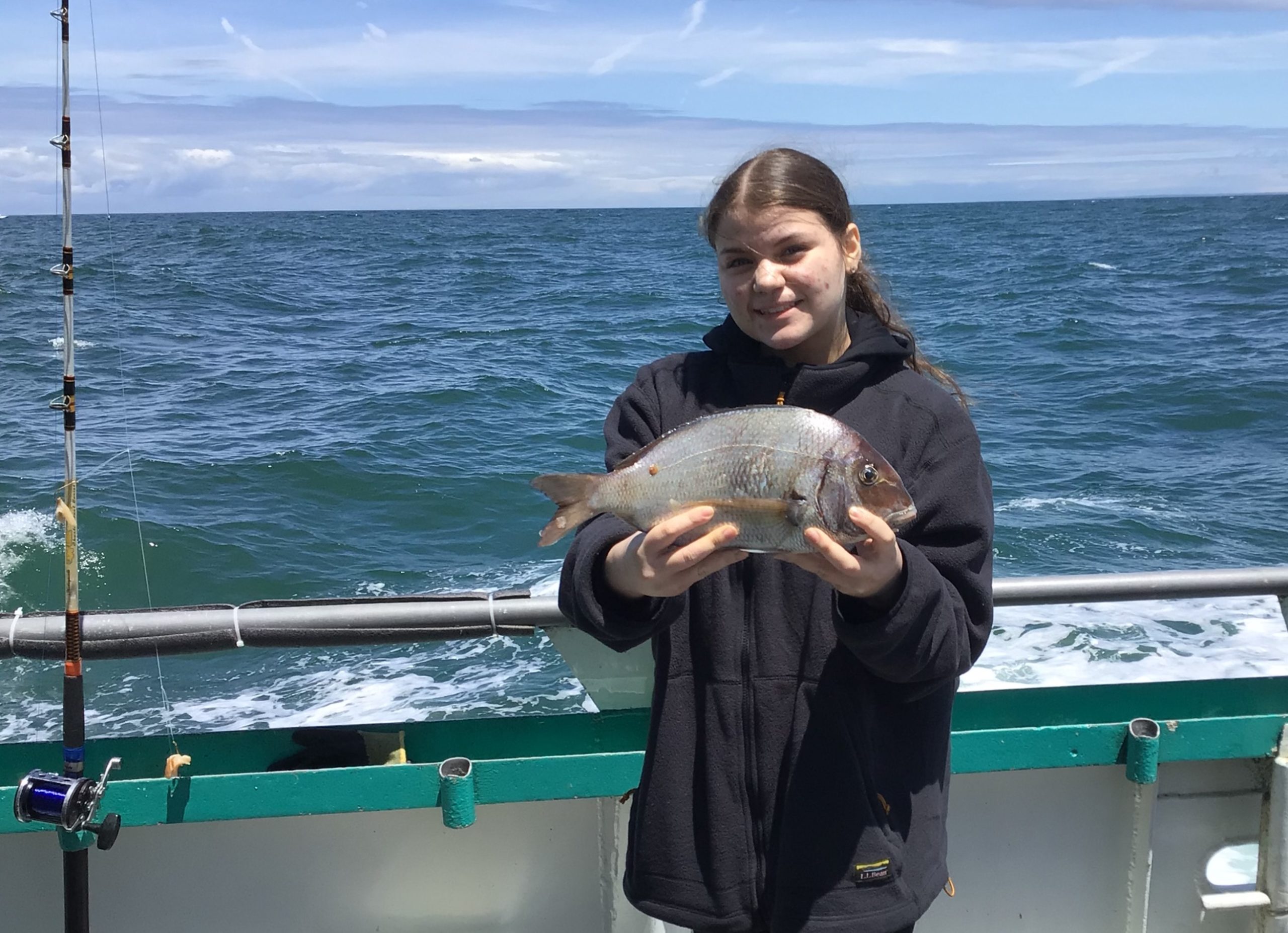 a person holding a fish in the water