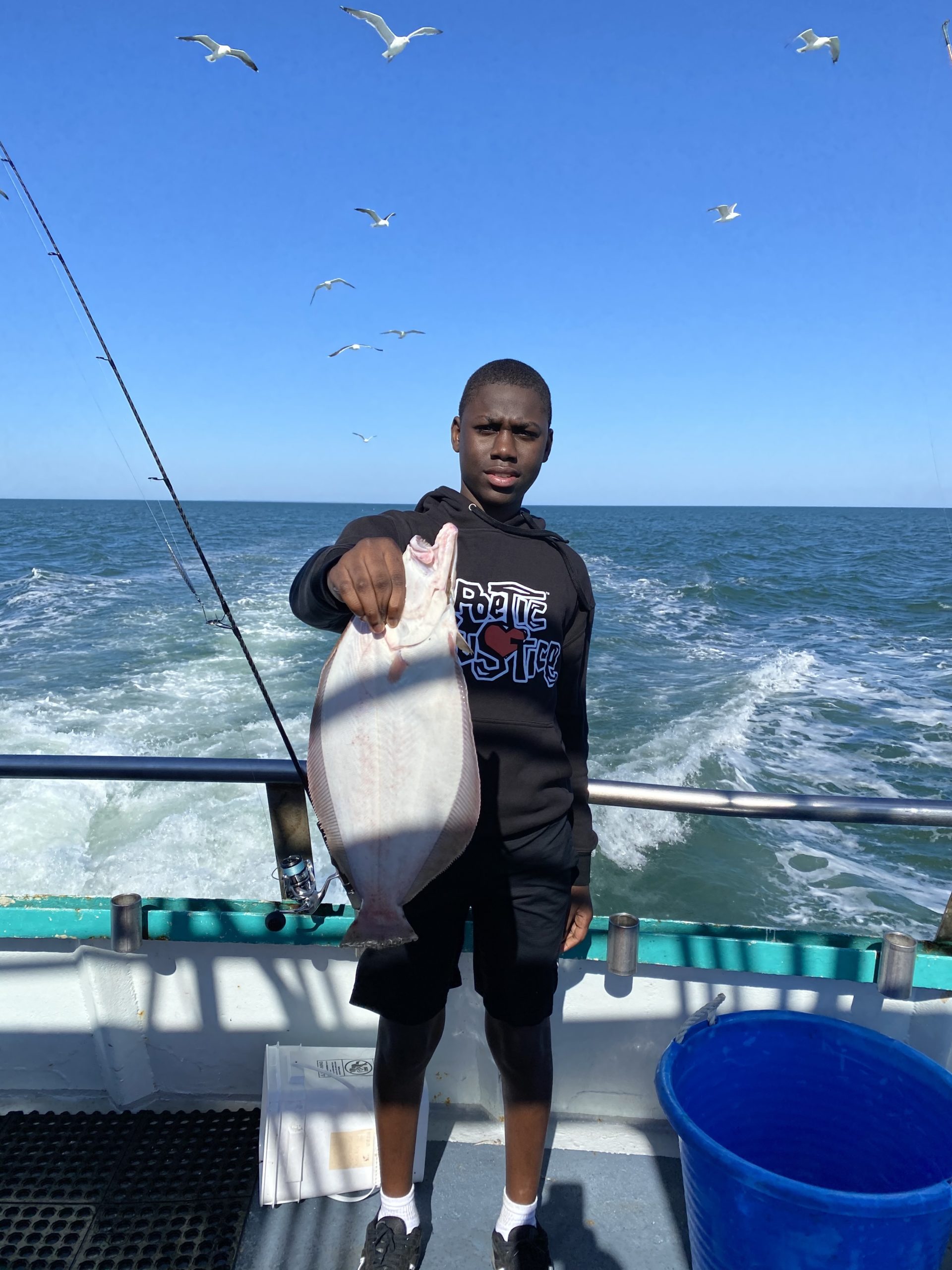a person standing next to a body of water