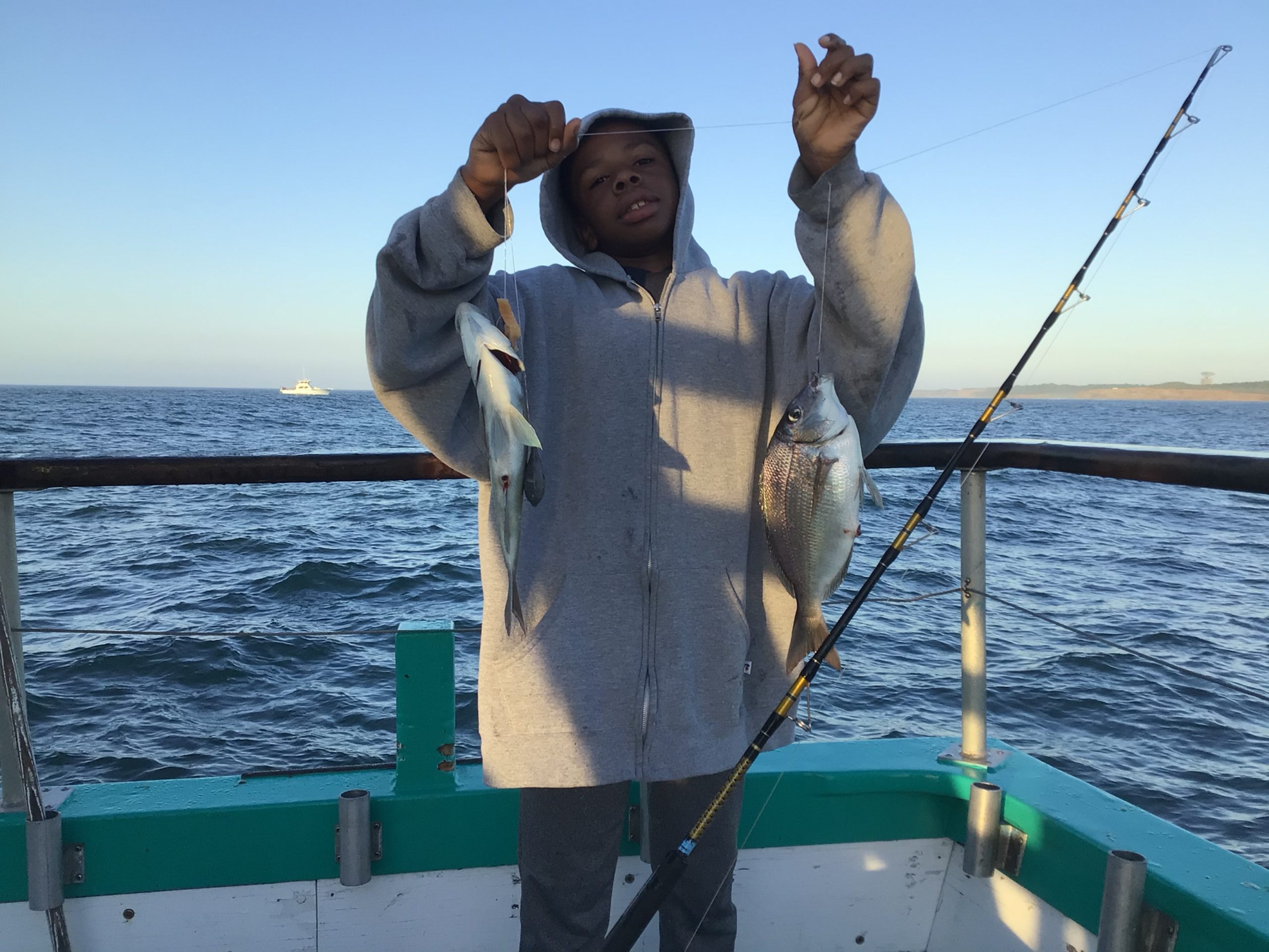 a man standing next to a body of water