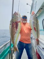 a person holding a fish in the water