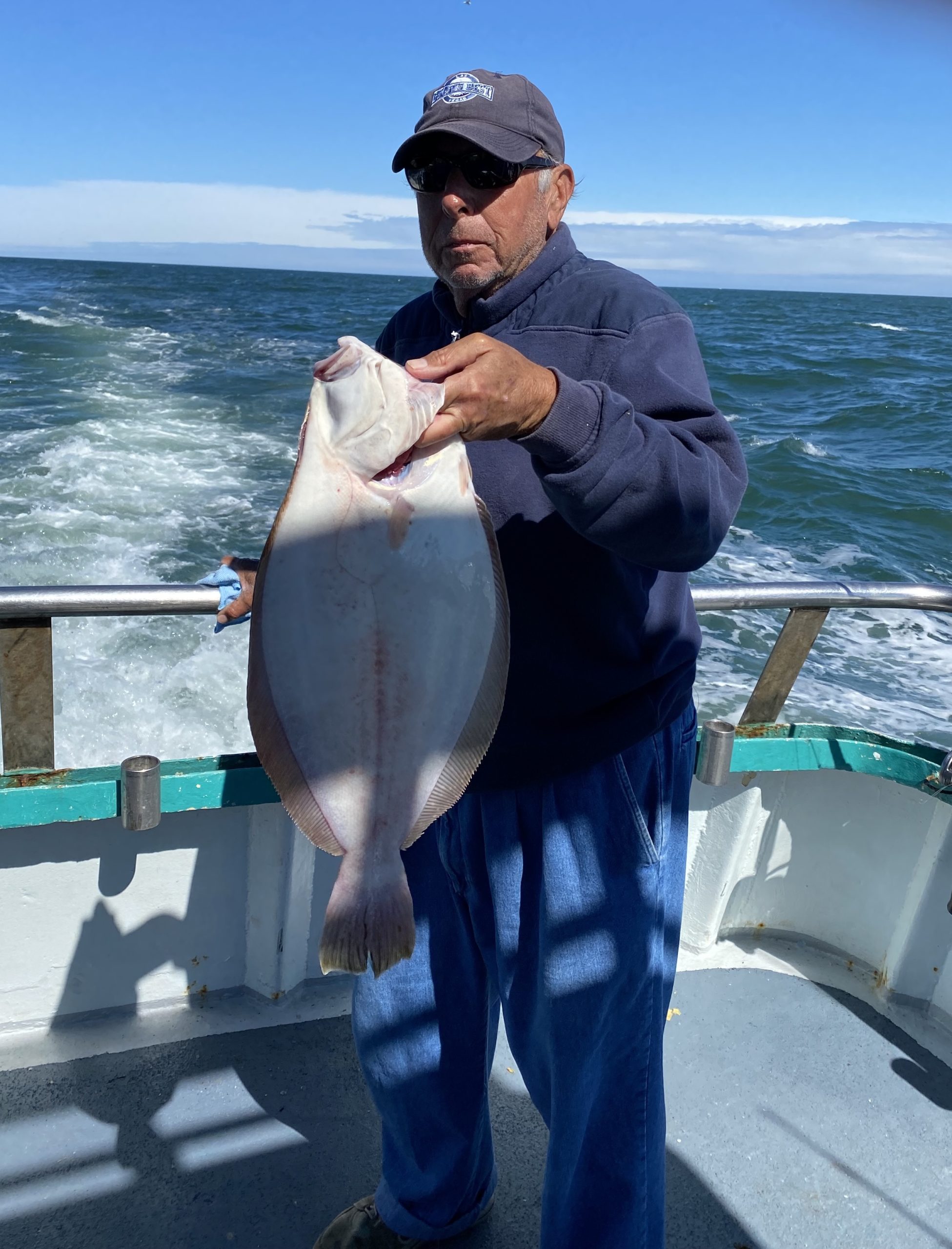 a man holding a fish in the water