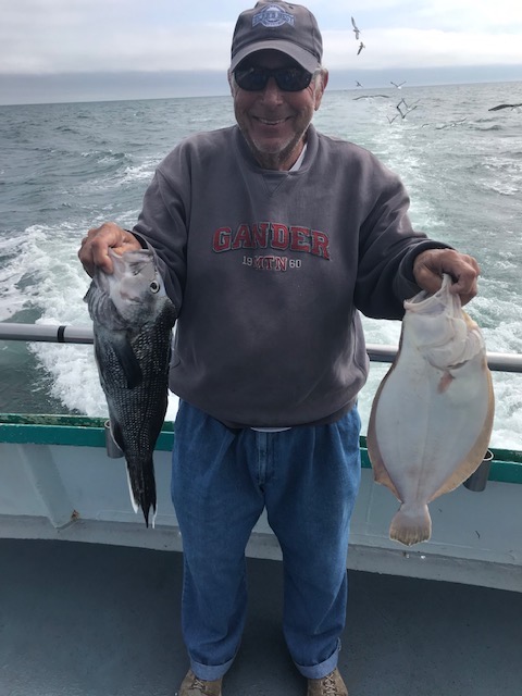 a man holding a fish in the water