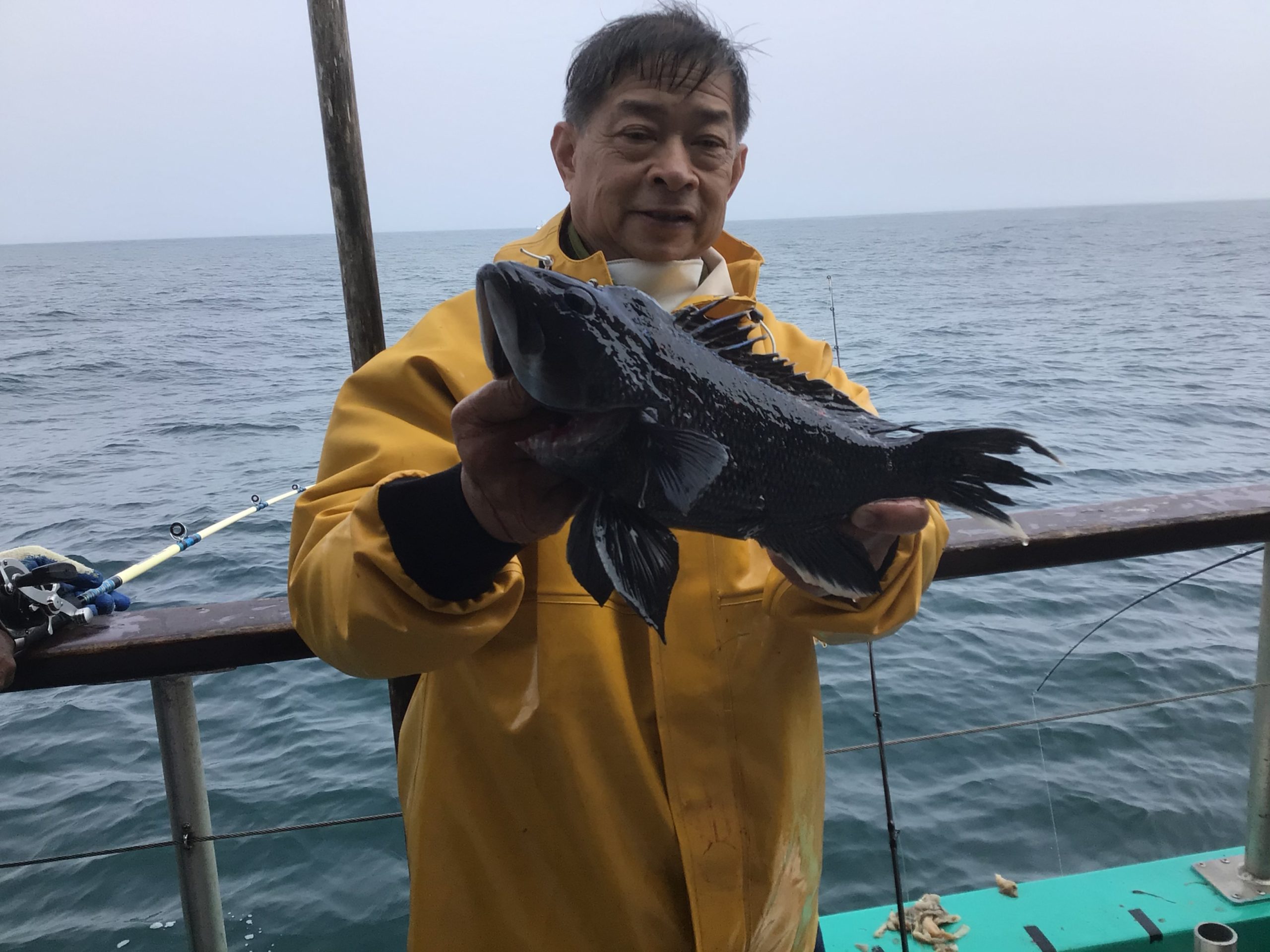 a man standing next to a body of water