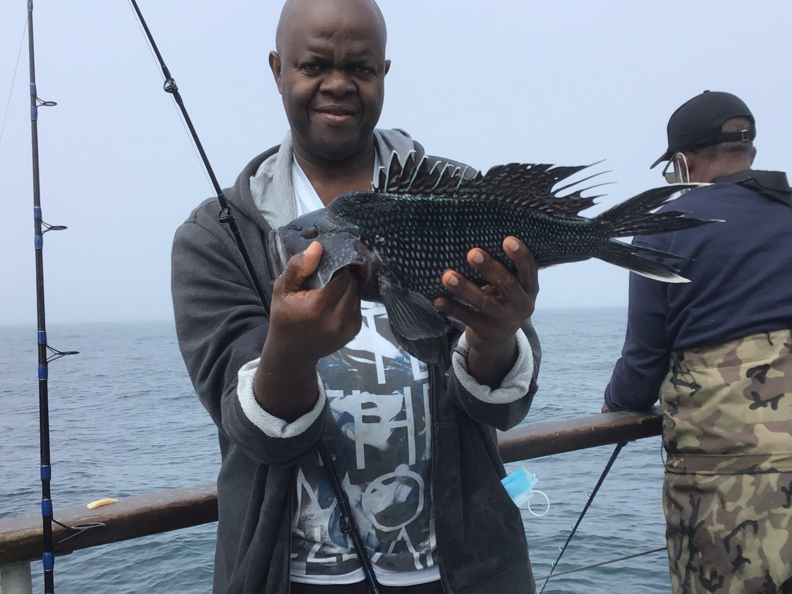 a man holding a fish in the water