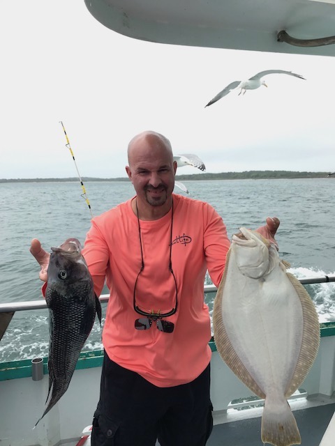 a person holding a fish in the water