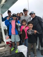 a group of people standing in front of a crowd posing for the camera