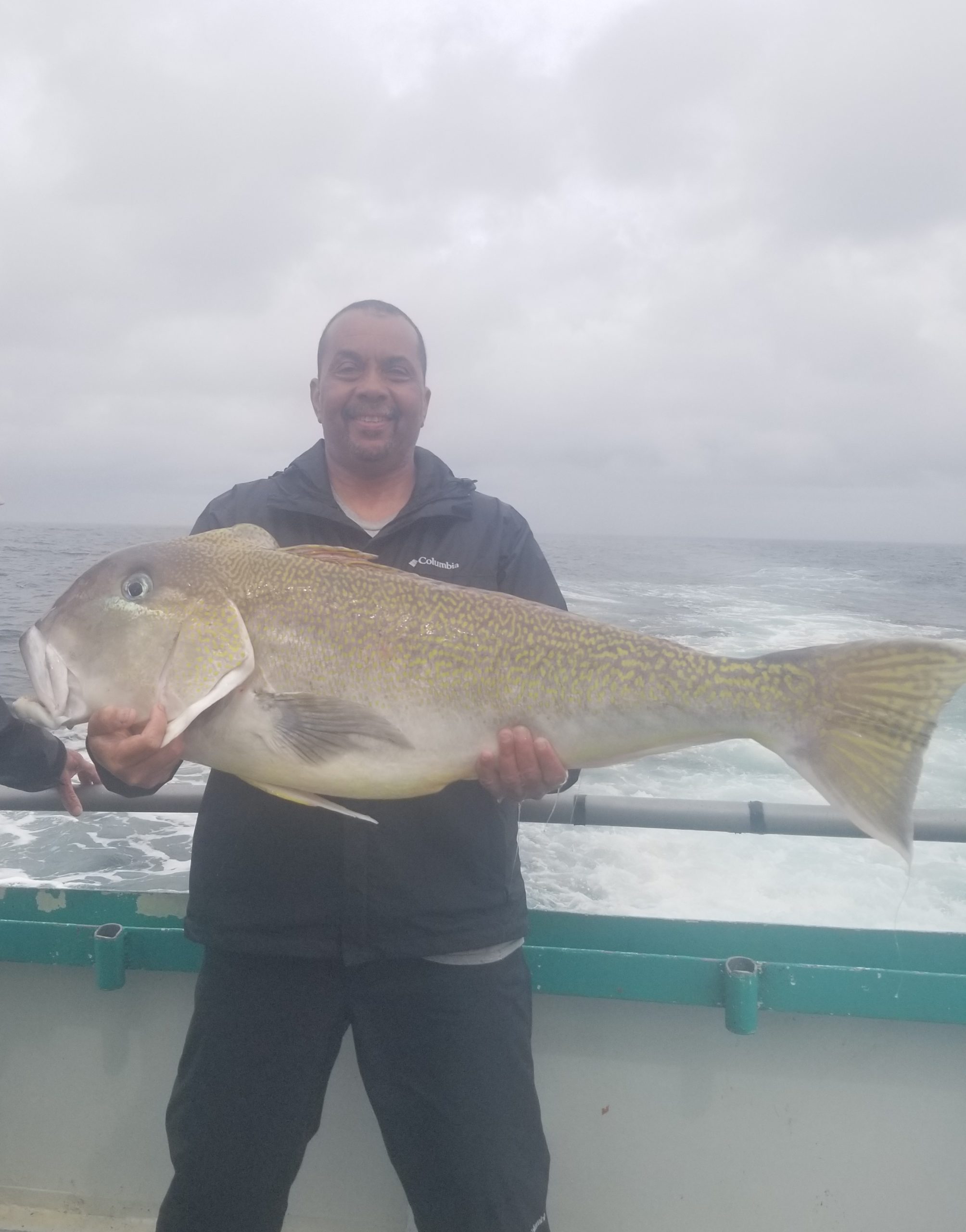 a man holding a fish in the water