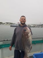 a man holding a fish in the water