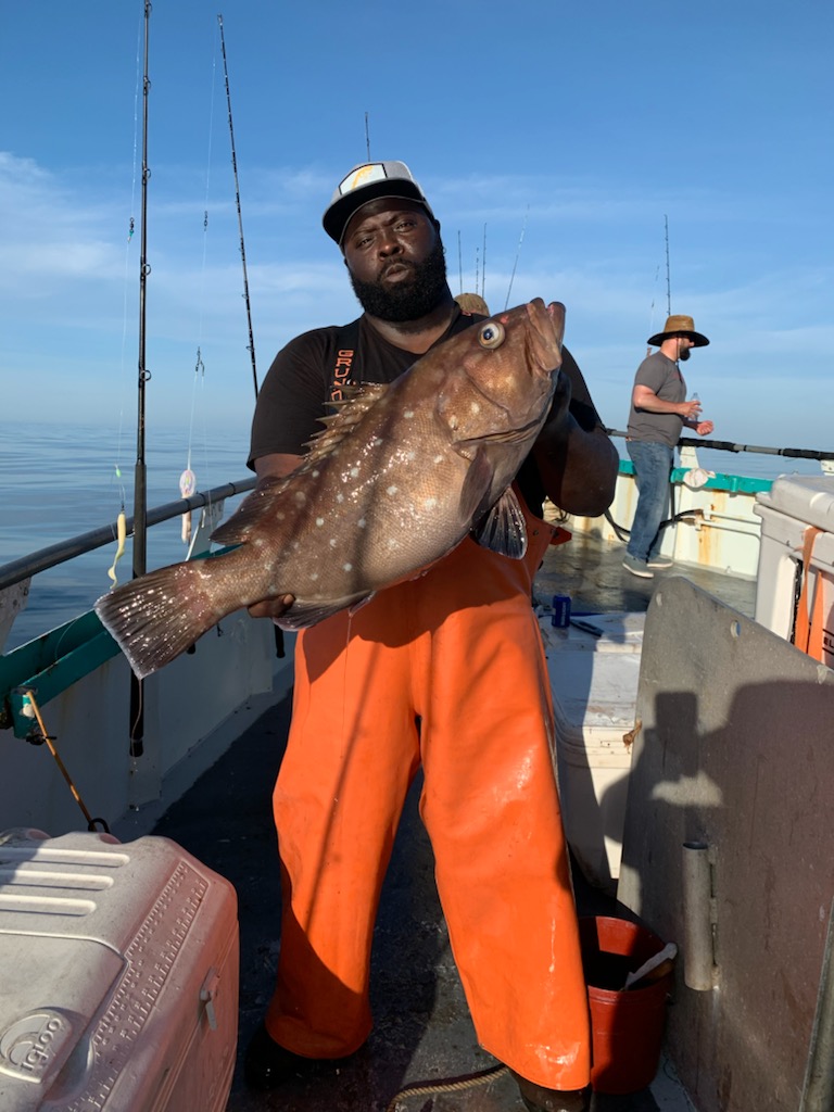 a man holding a fish