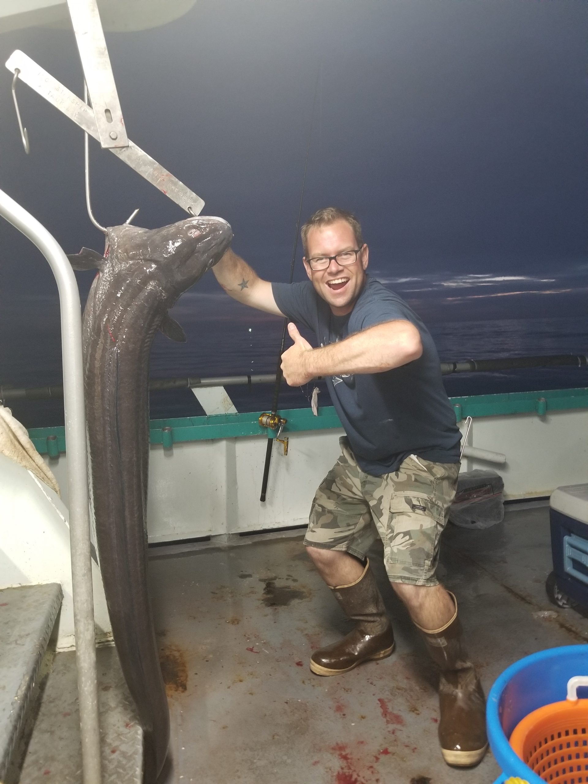 a man standing in front of a blue wall