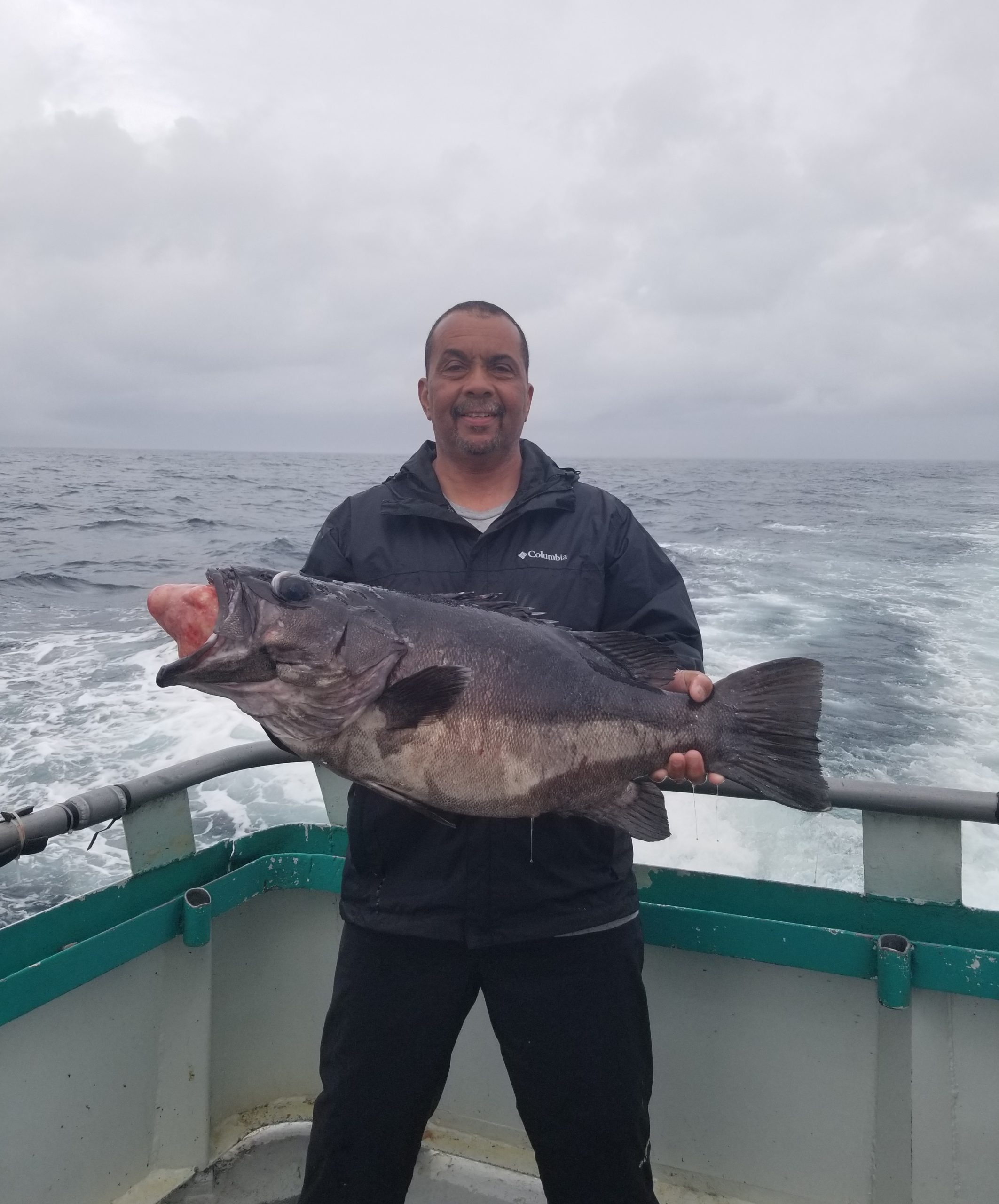 a man holding a fish in the water