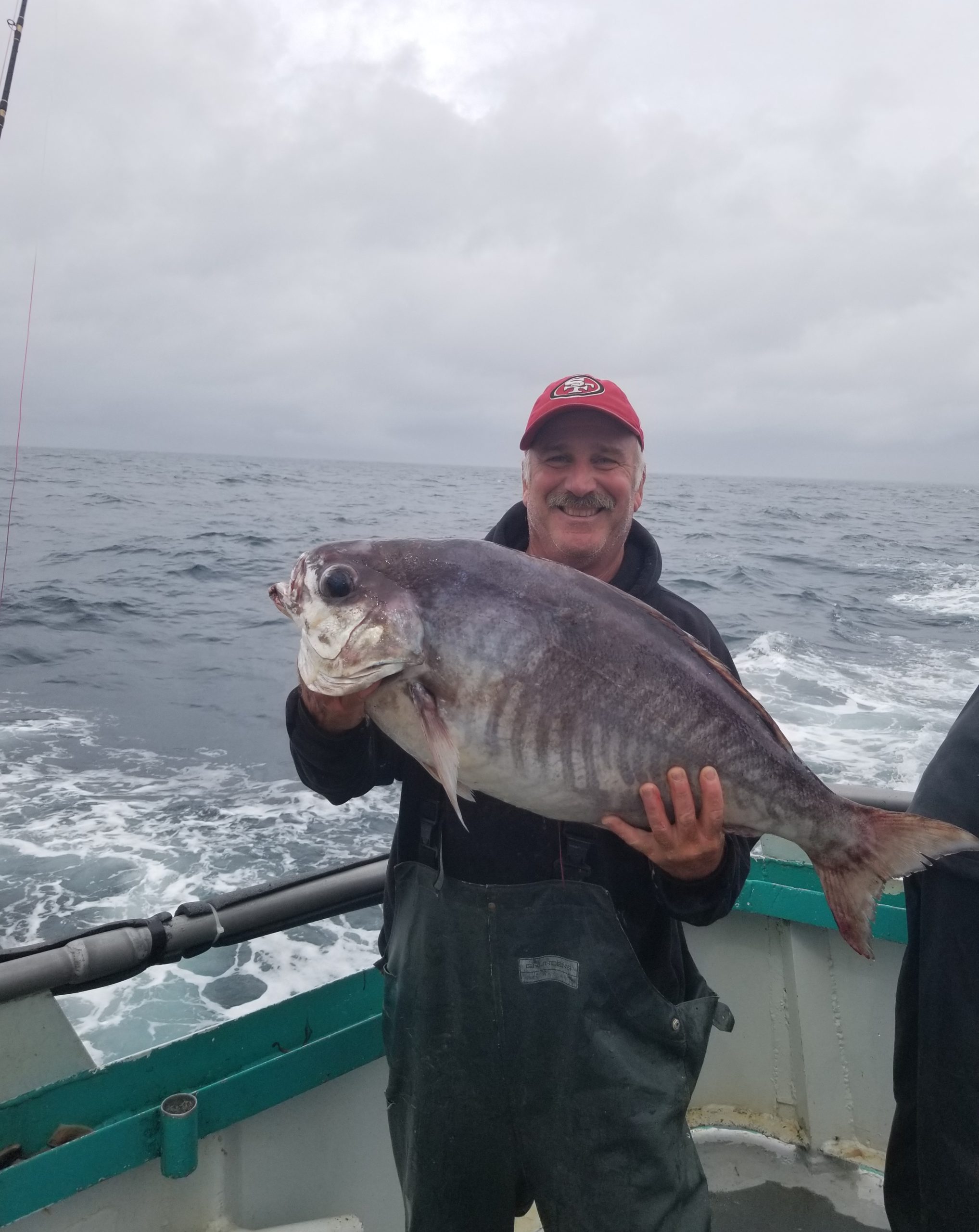 a man holding a fish in the water