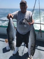 a man holding a fish in the water