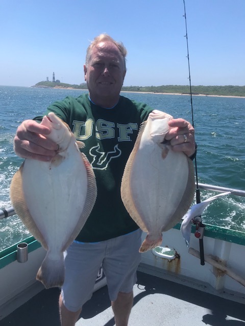 a man holding a fish in the water
