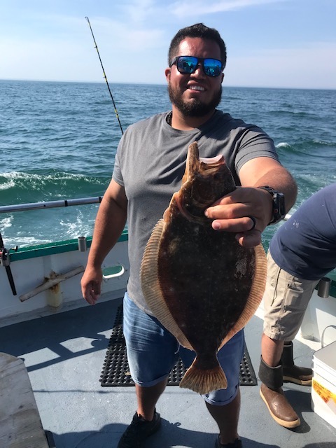 a person holding a fish in the water