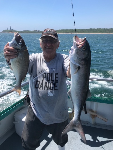 a man holding a fish in the water
