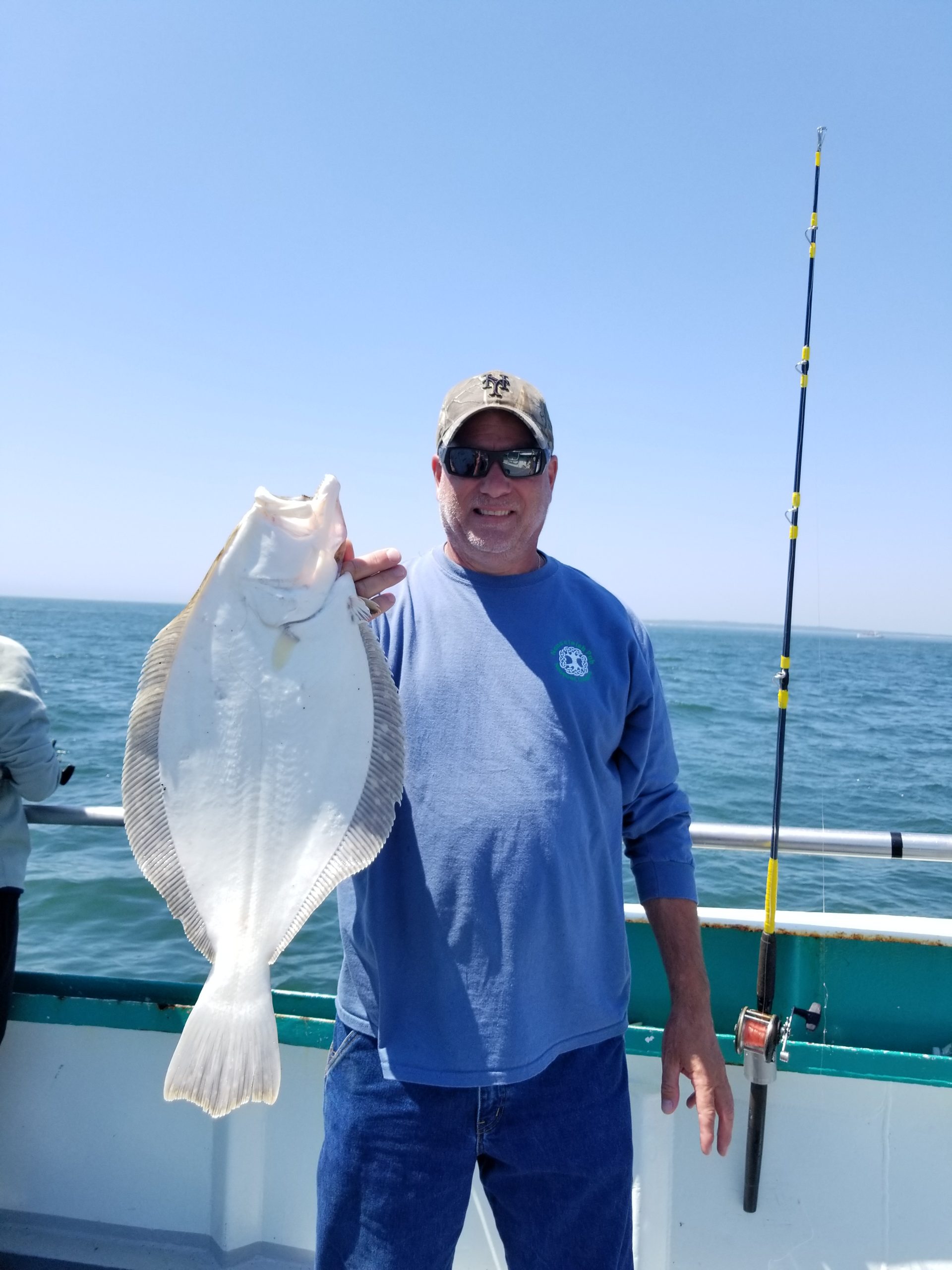 a man holding a fish in the water