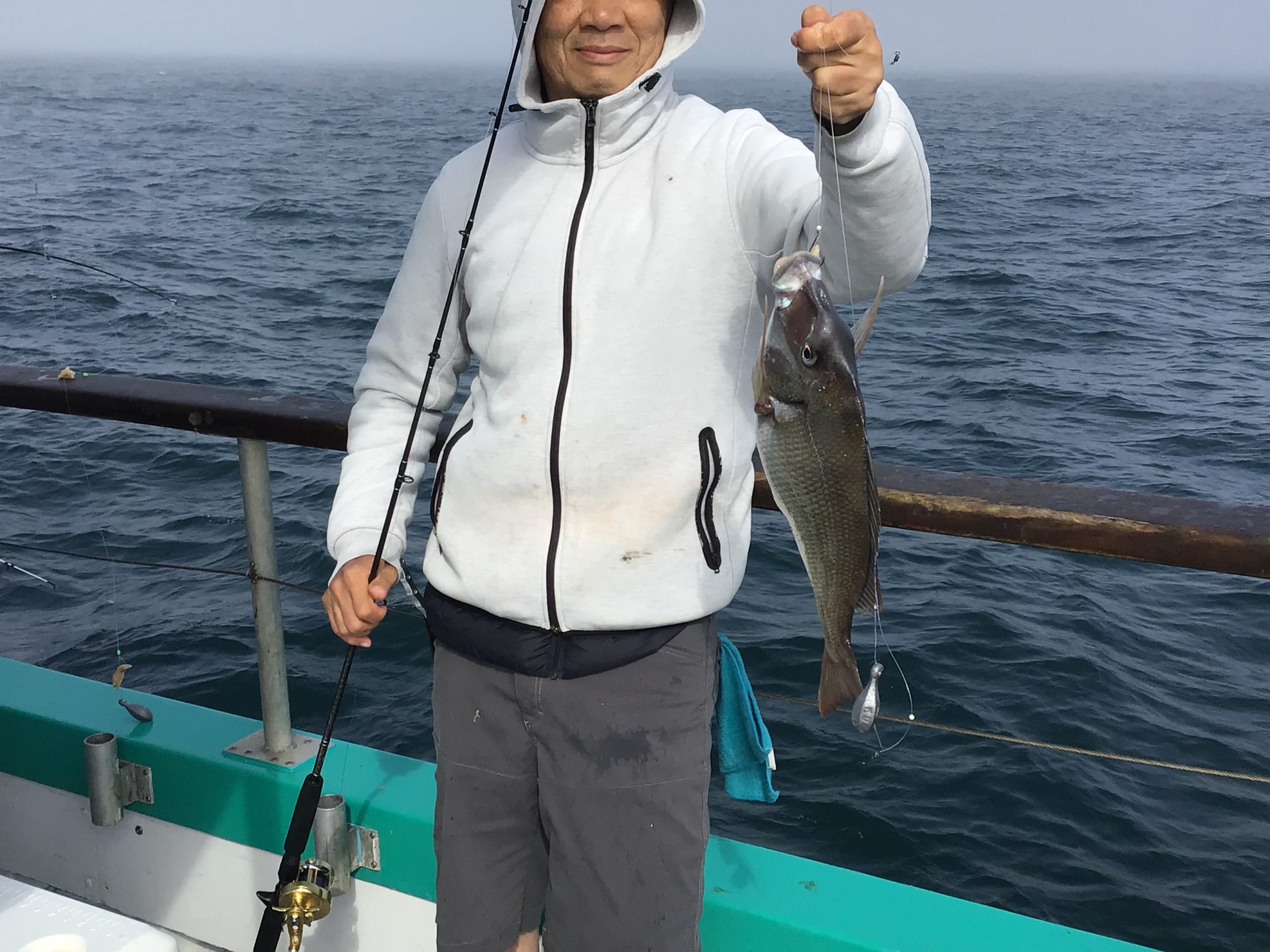 a man holding a fish in the water