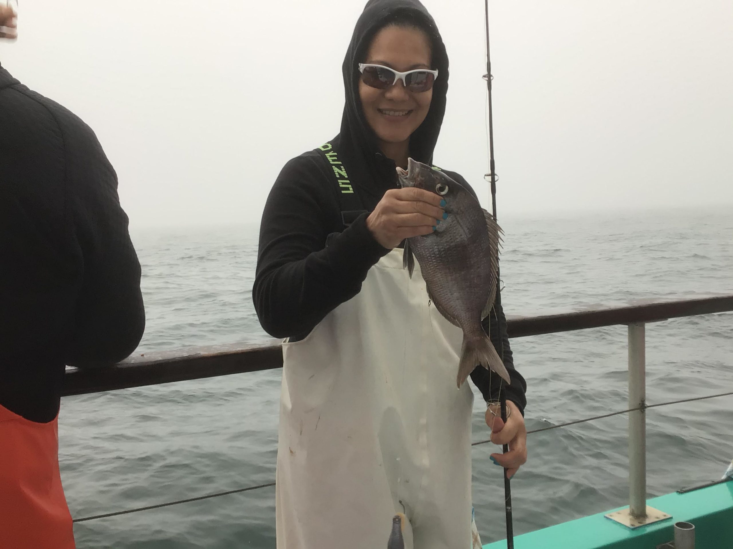 a person holding a fish in the water