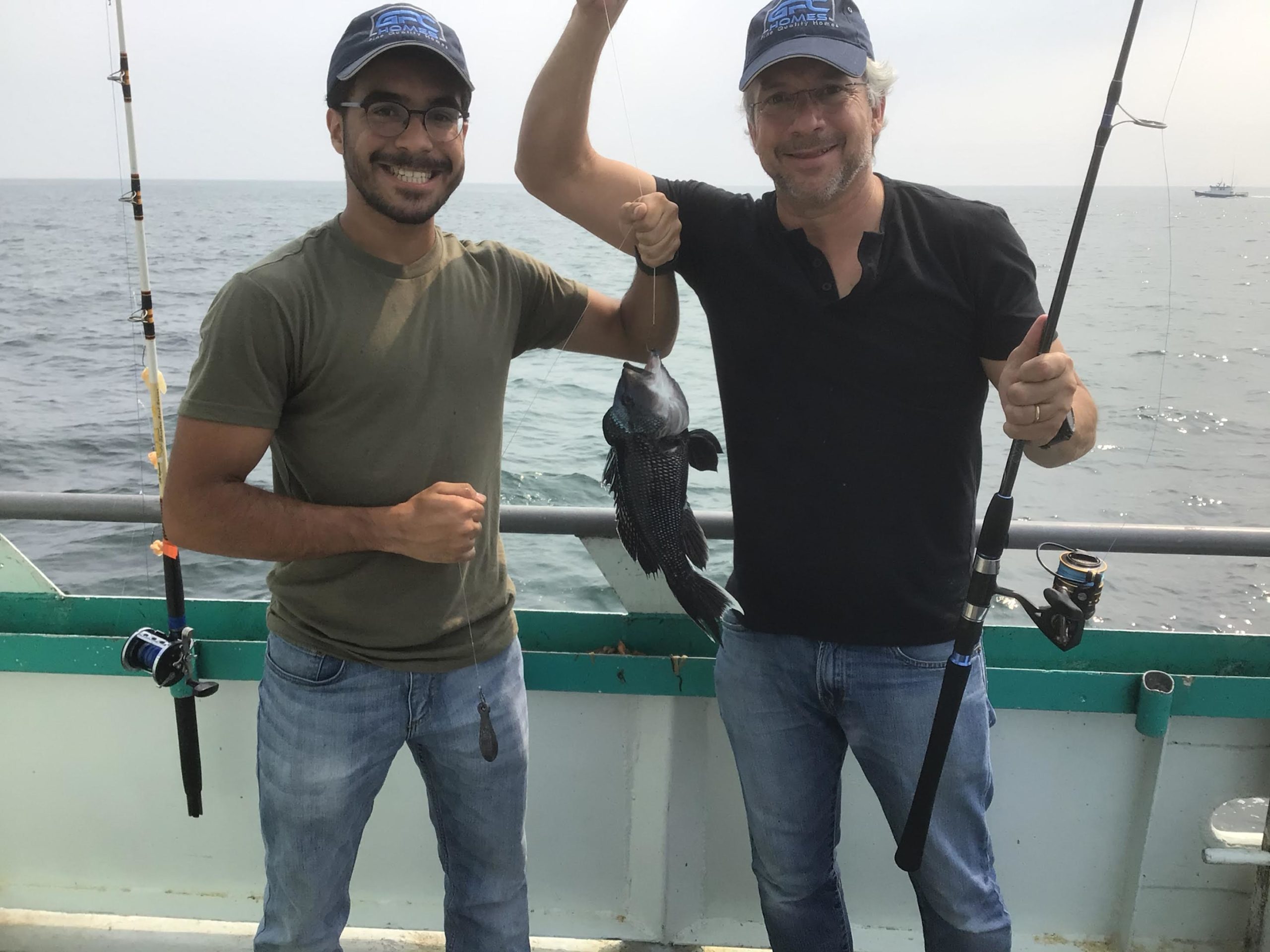 a man standing next to a body of water