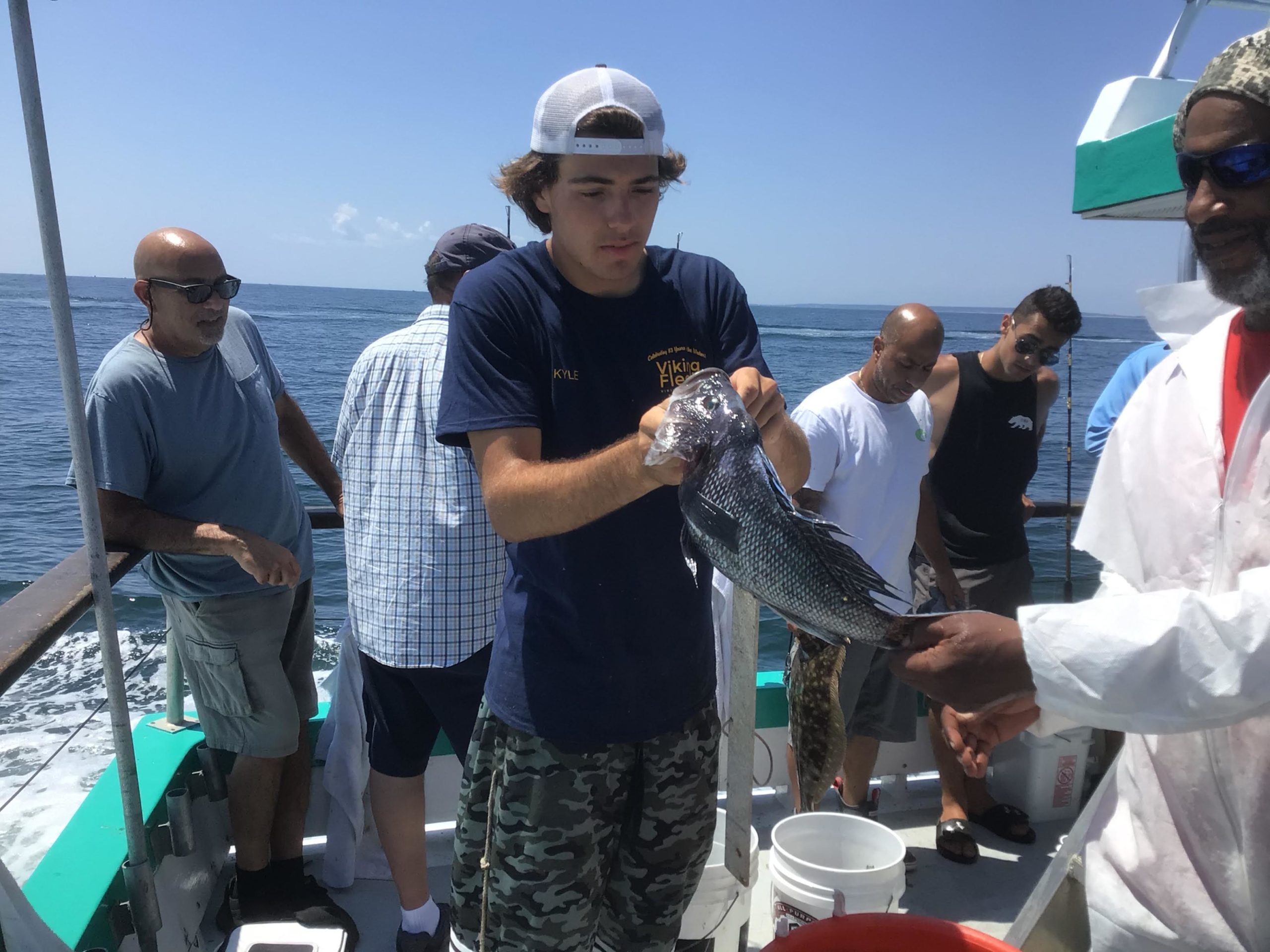 a man holding a fish in the water