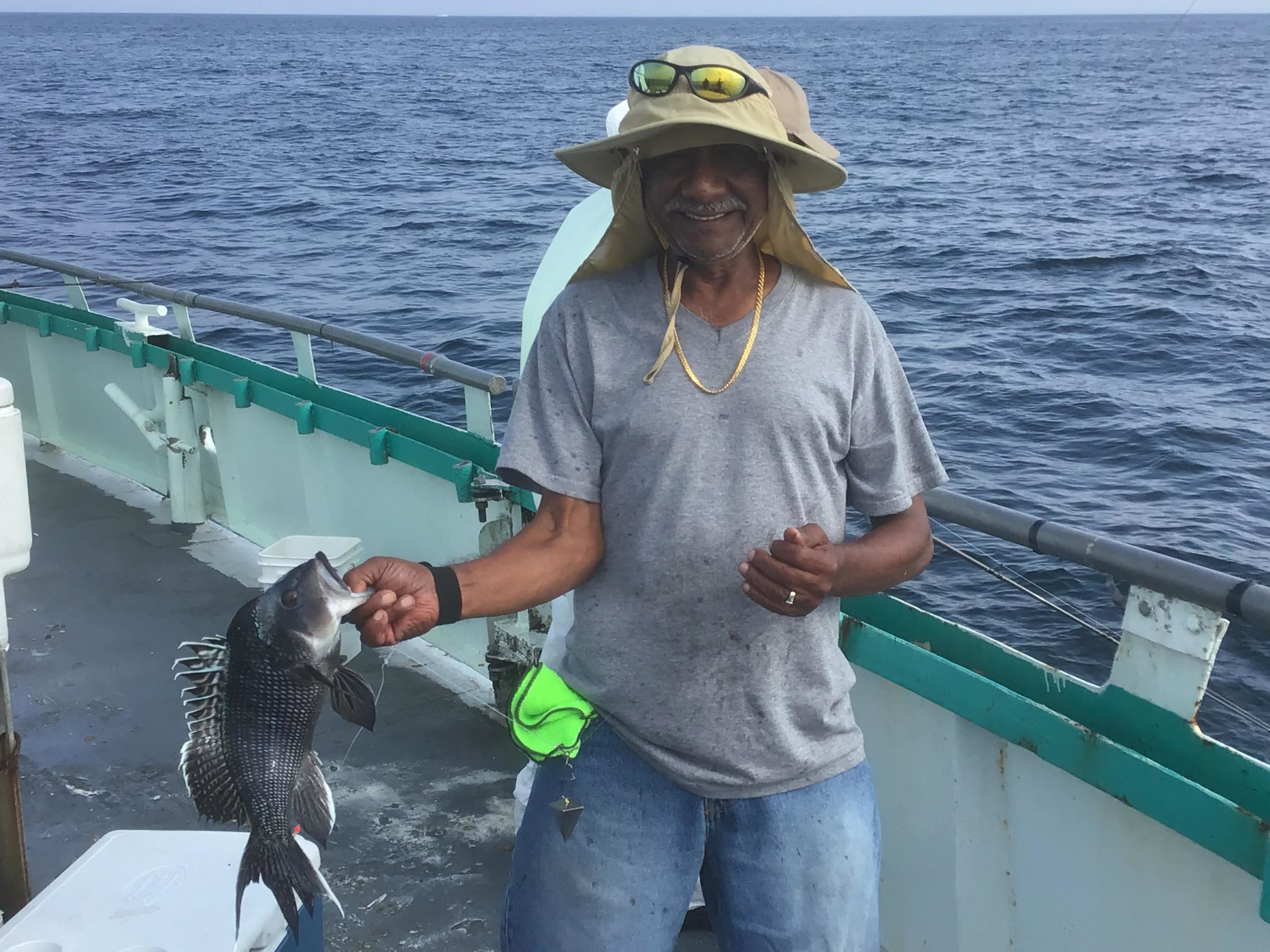 a person holding a fish in the water