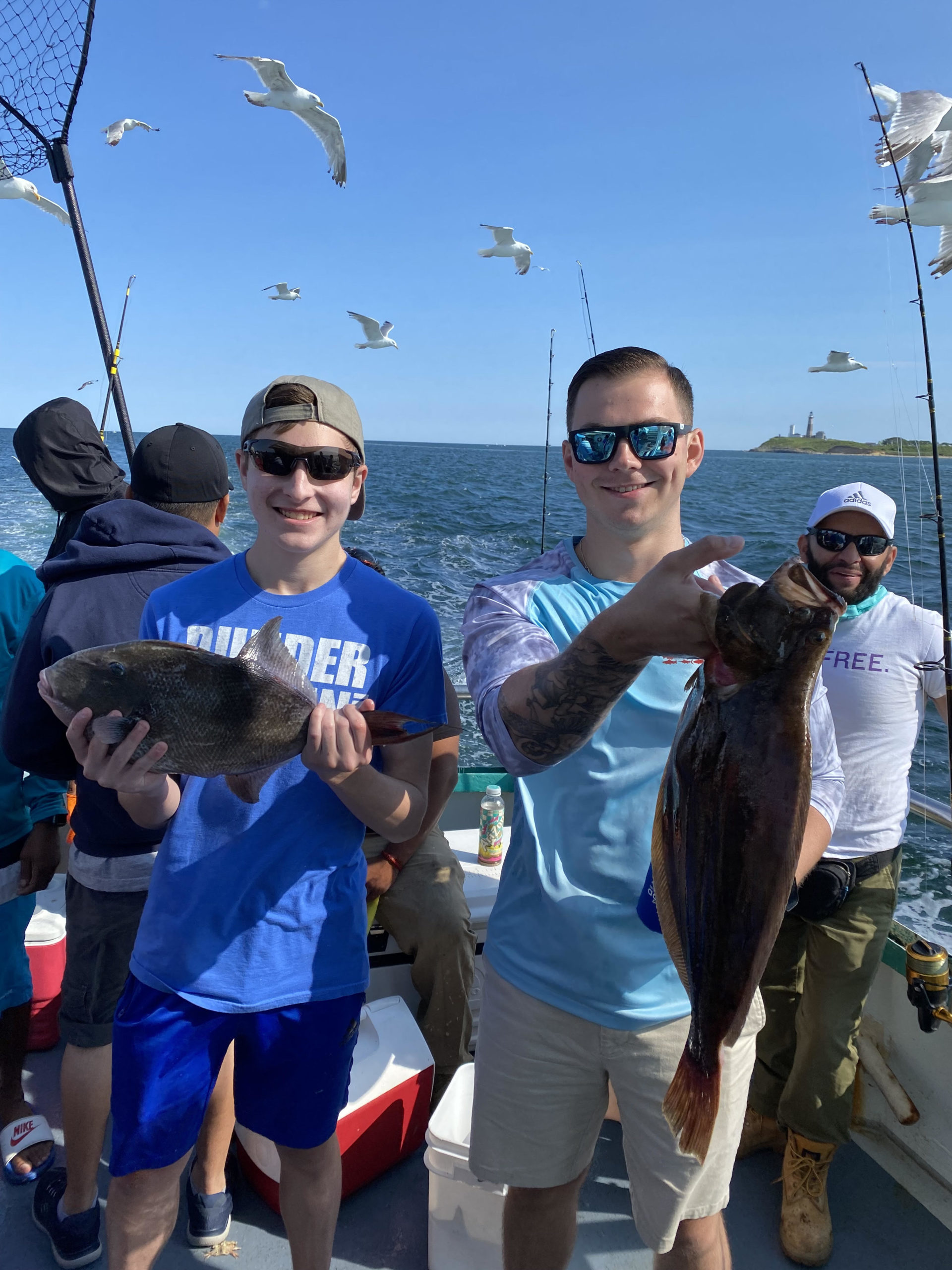 a group of people standing next to a person holding a fish