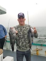 a man holding a fish