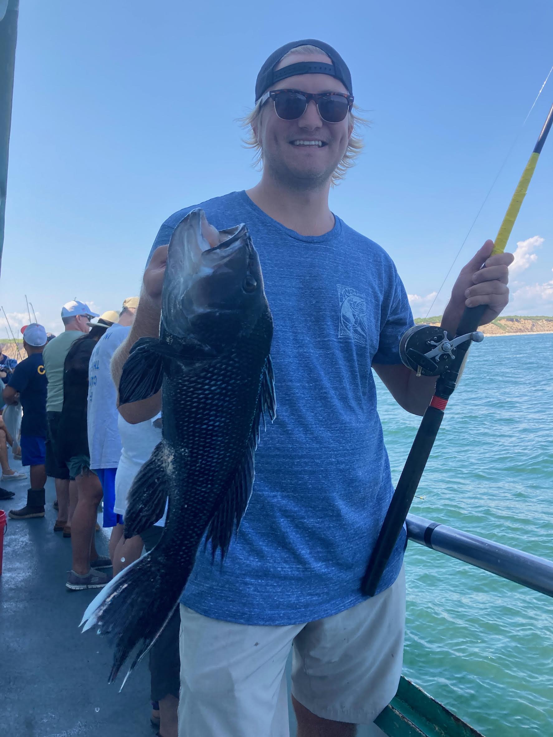 a man holding a fish in the water