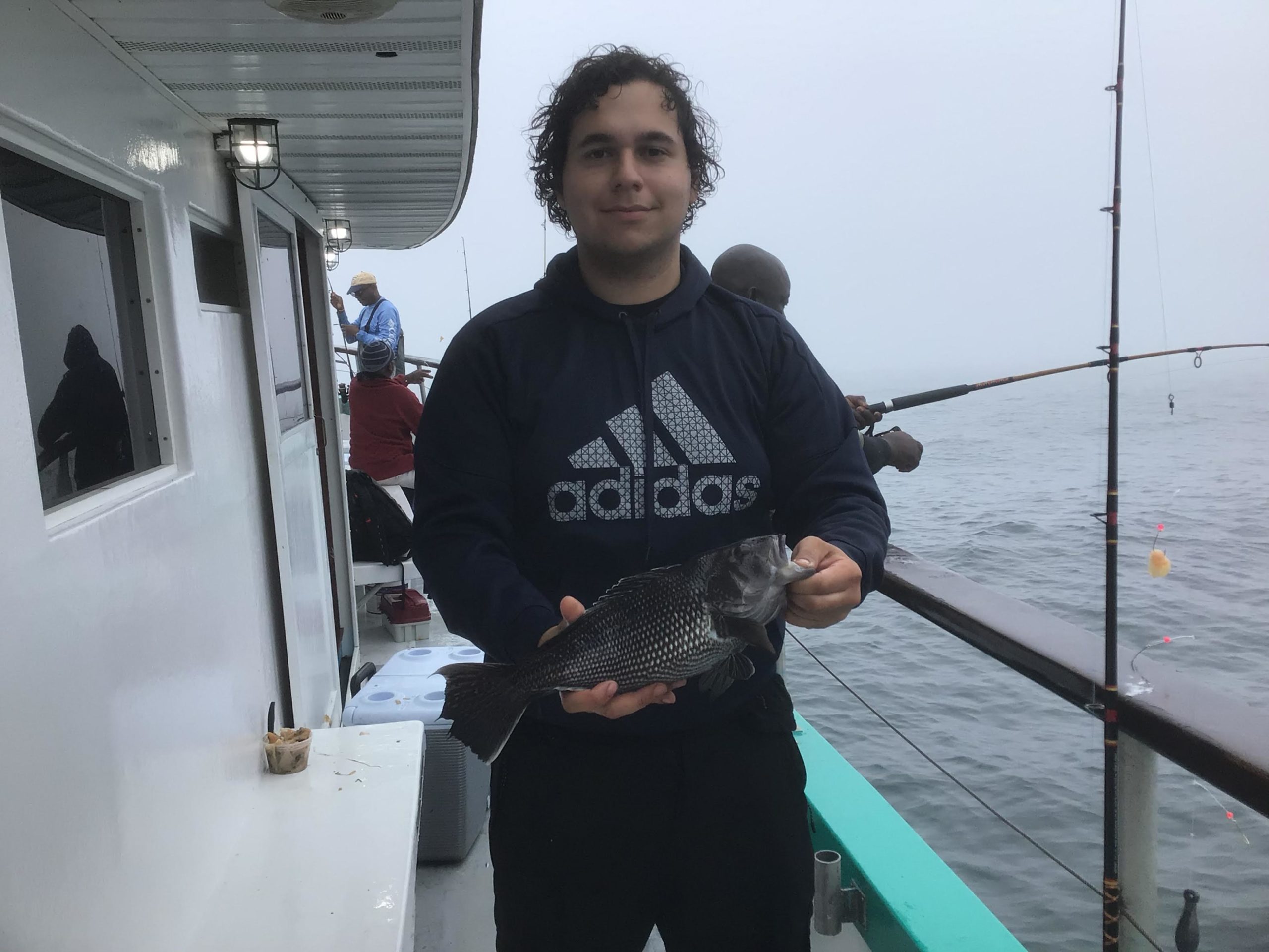 a man holding a fish in the water