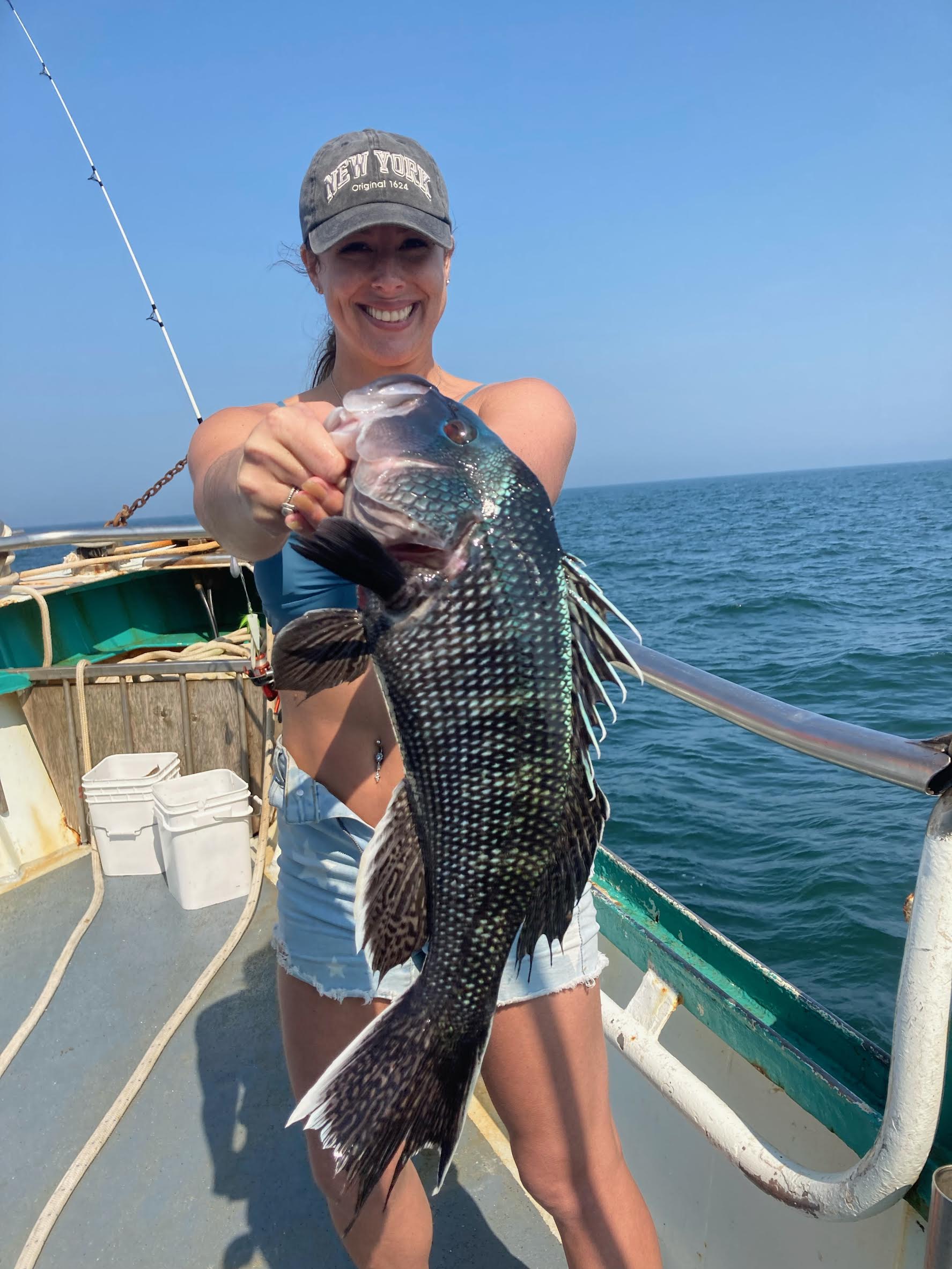 a person holding a fish in the water