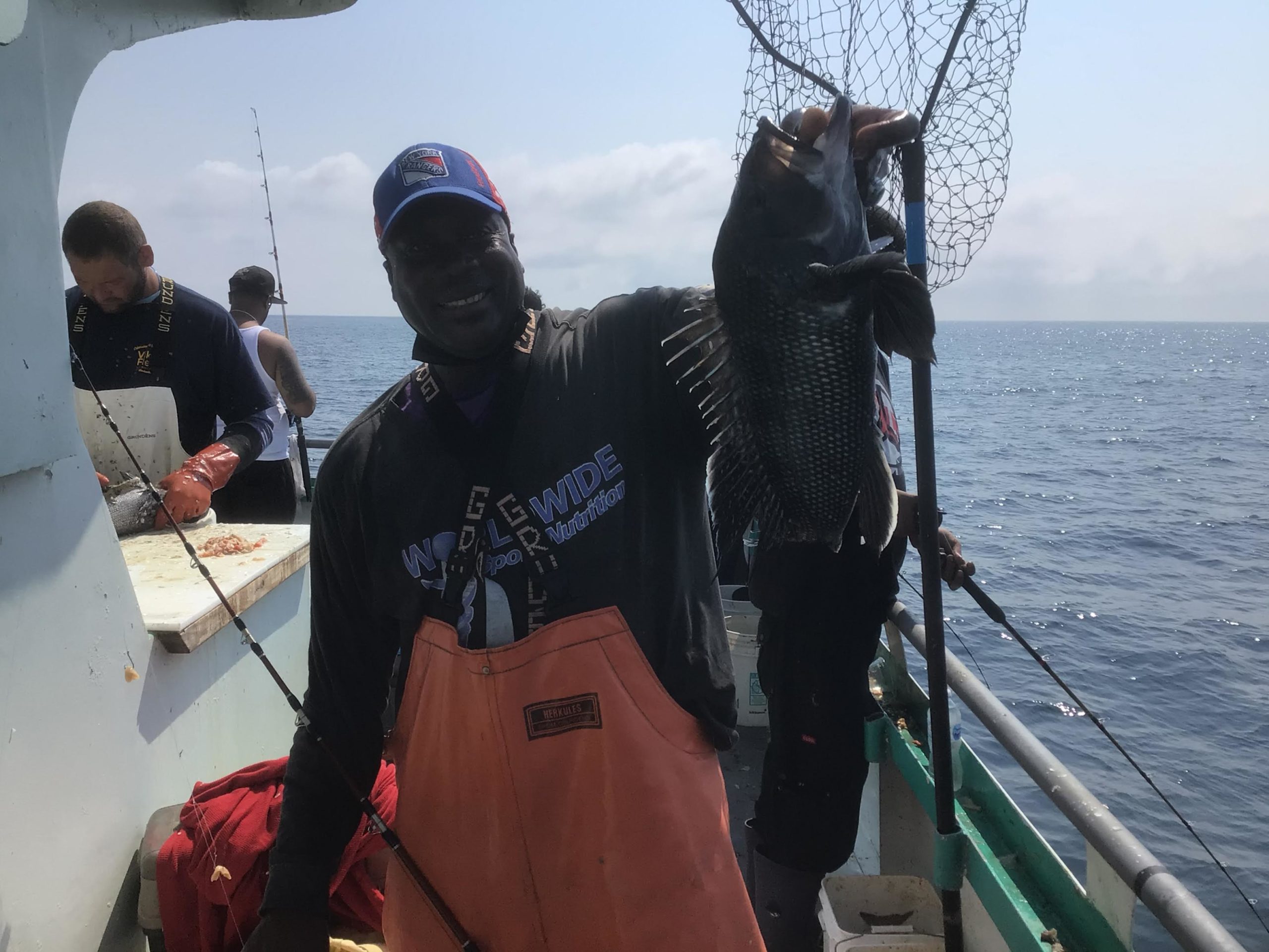 a person holding a fish on a boat in the water