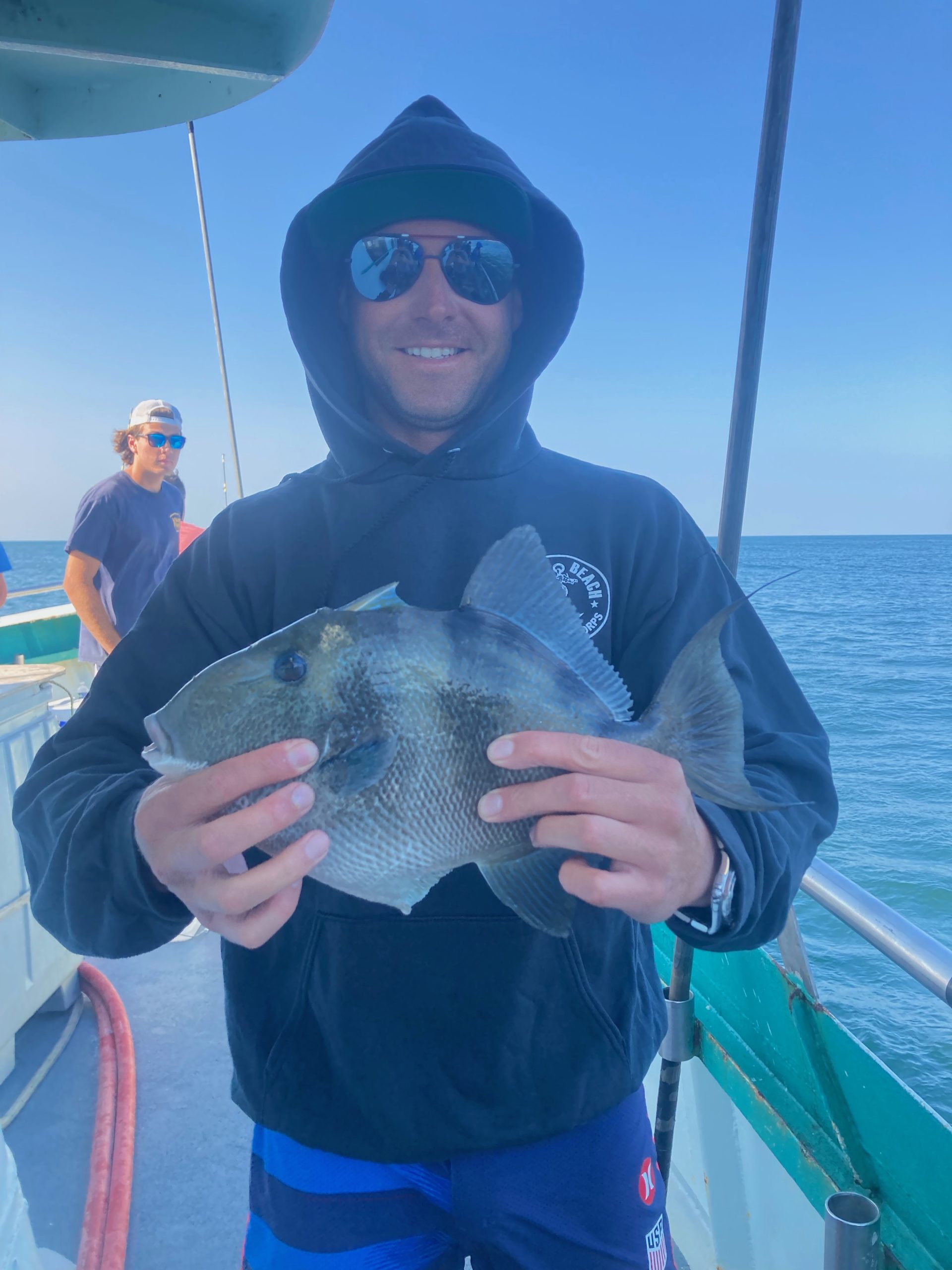 a man holding a fish in the water