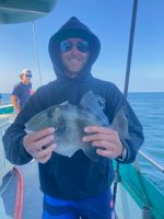 a man holding a fish in the water
