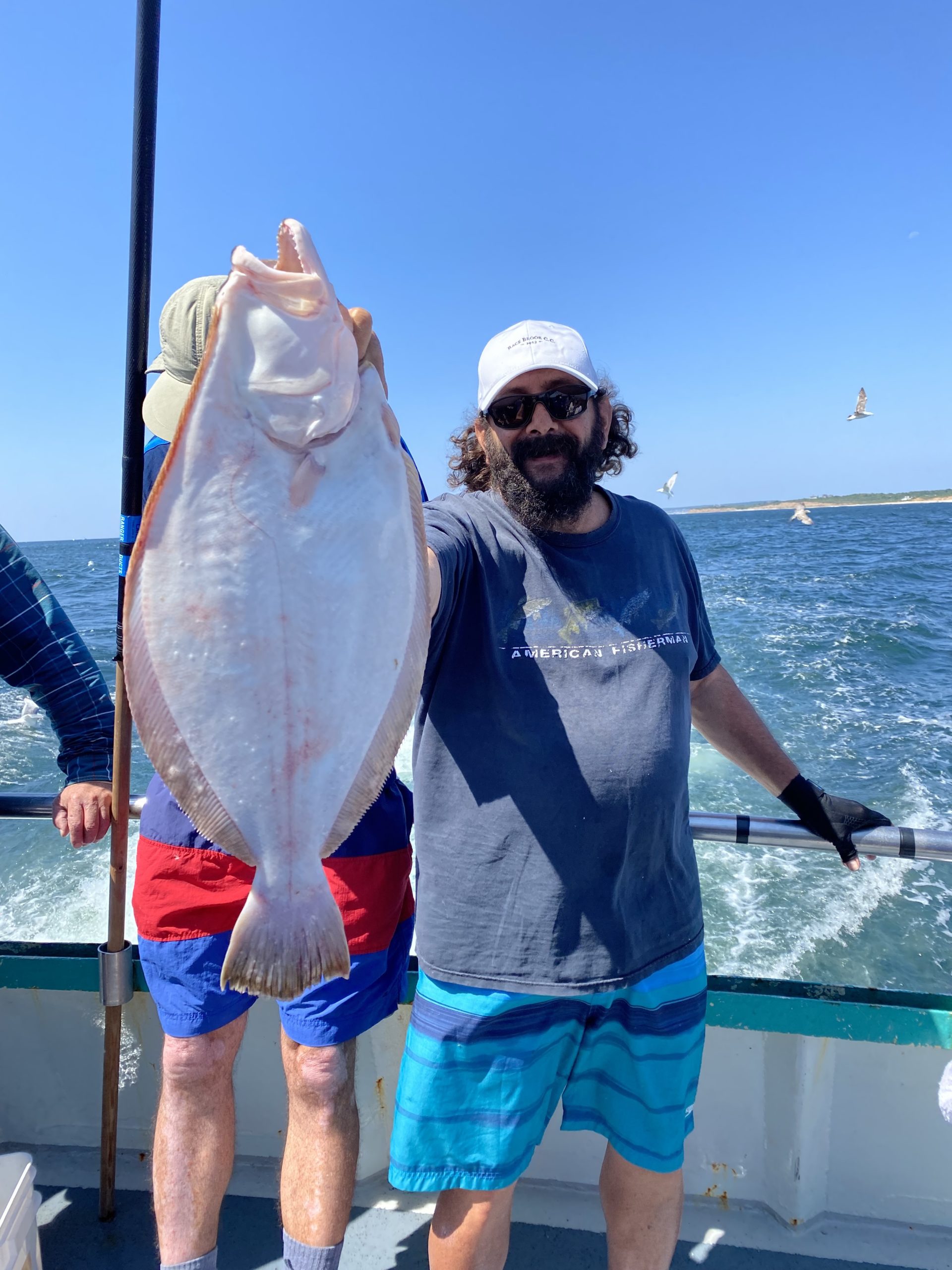 a man holding a fish in the water