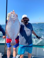 a man holding a fish in the water
