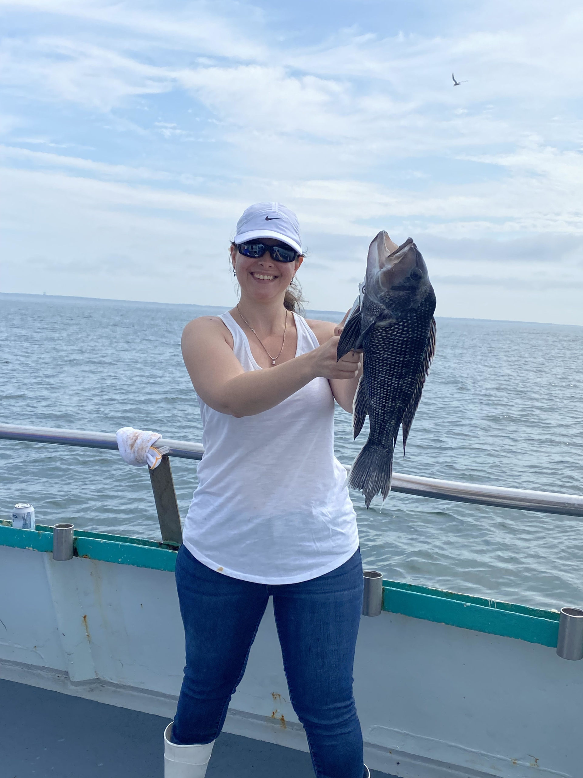 a woman standing next to a body of water