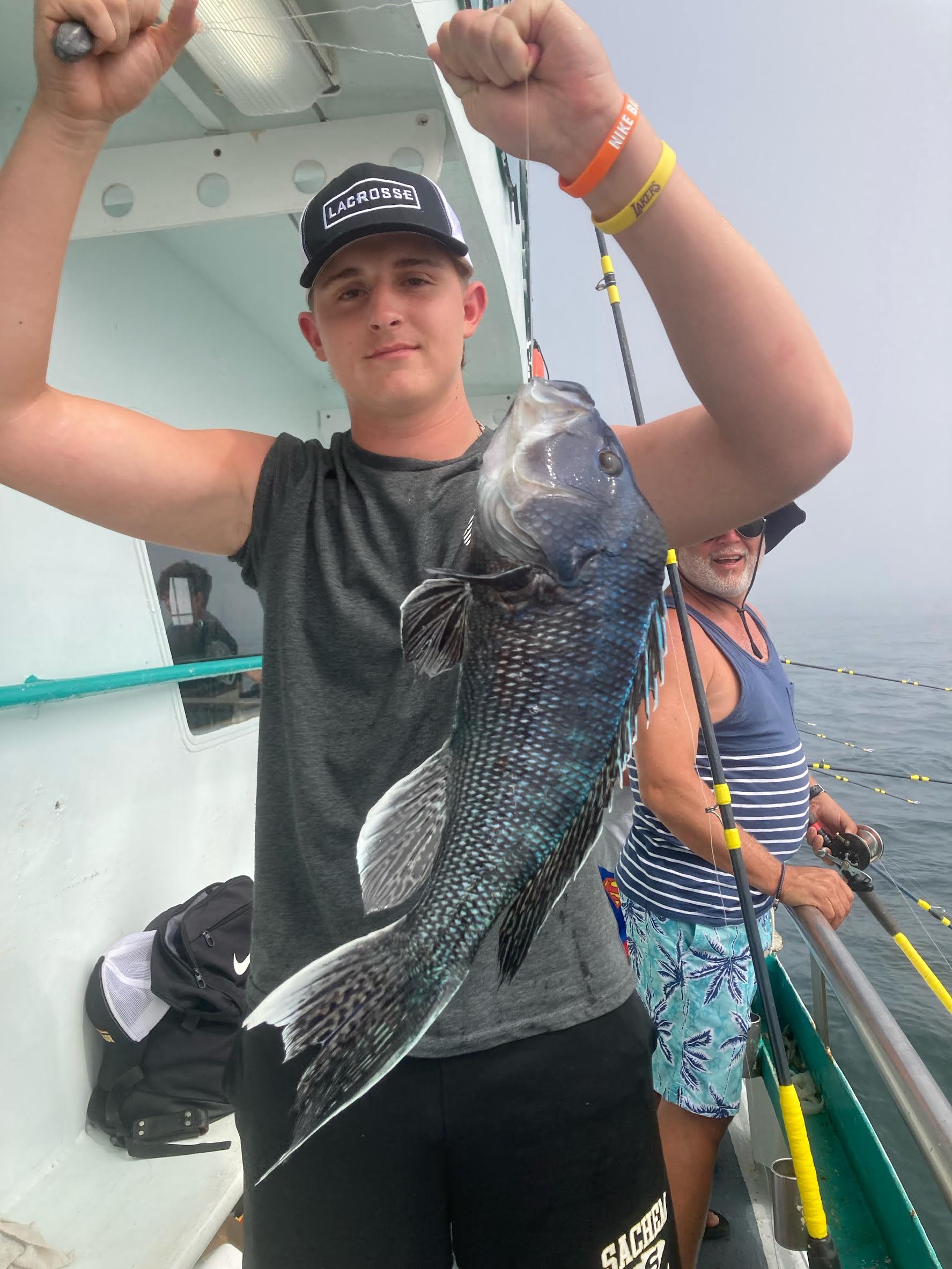 a young man holding a fish