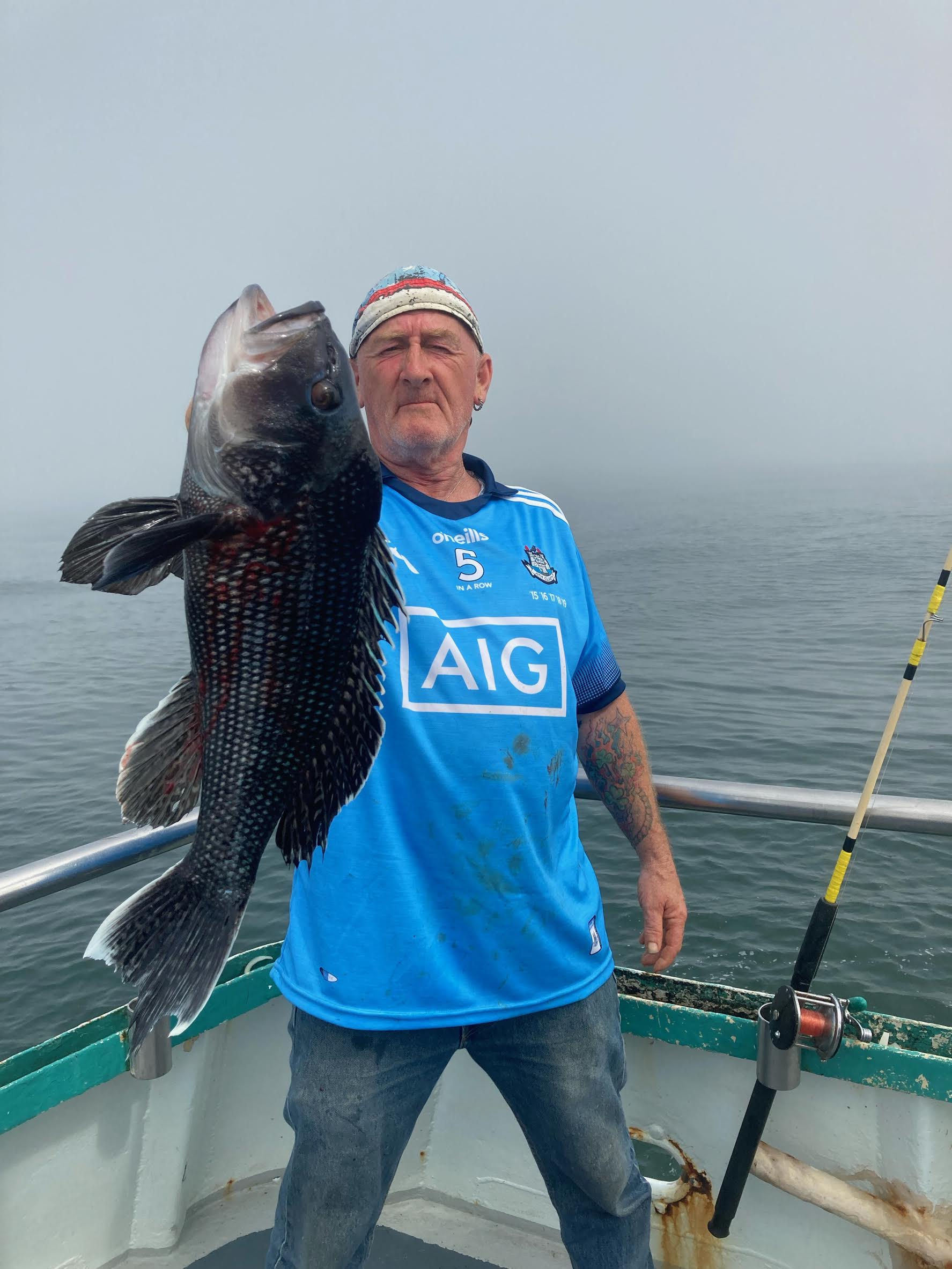 a man standing next to a body of water