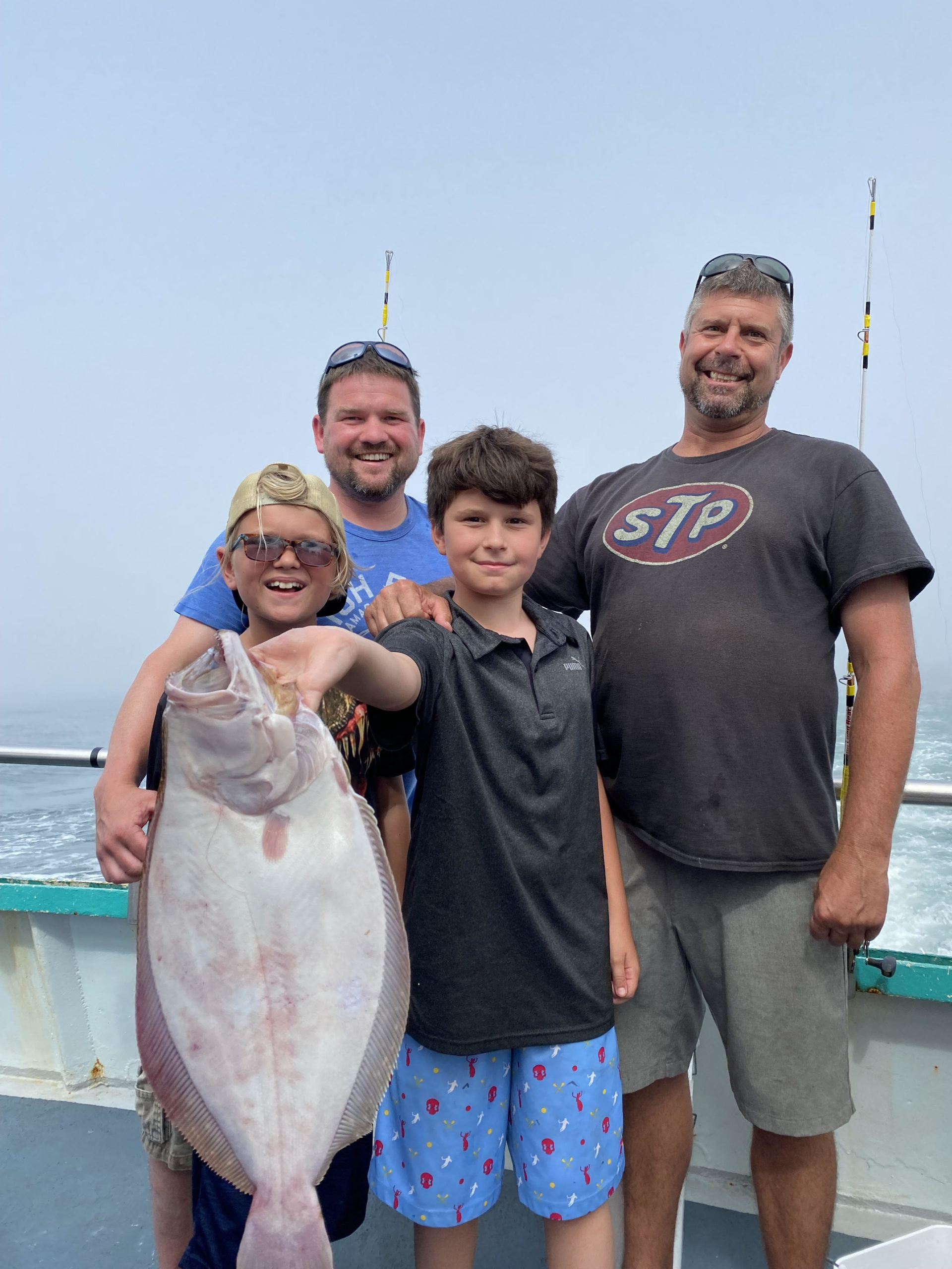 a person holding a fish posing for the camera