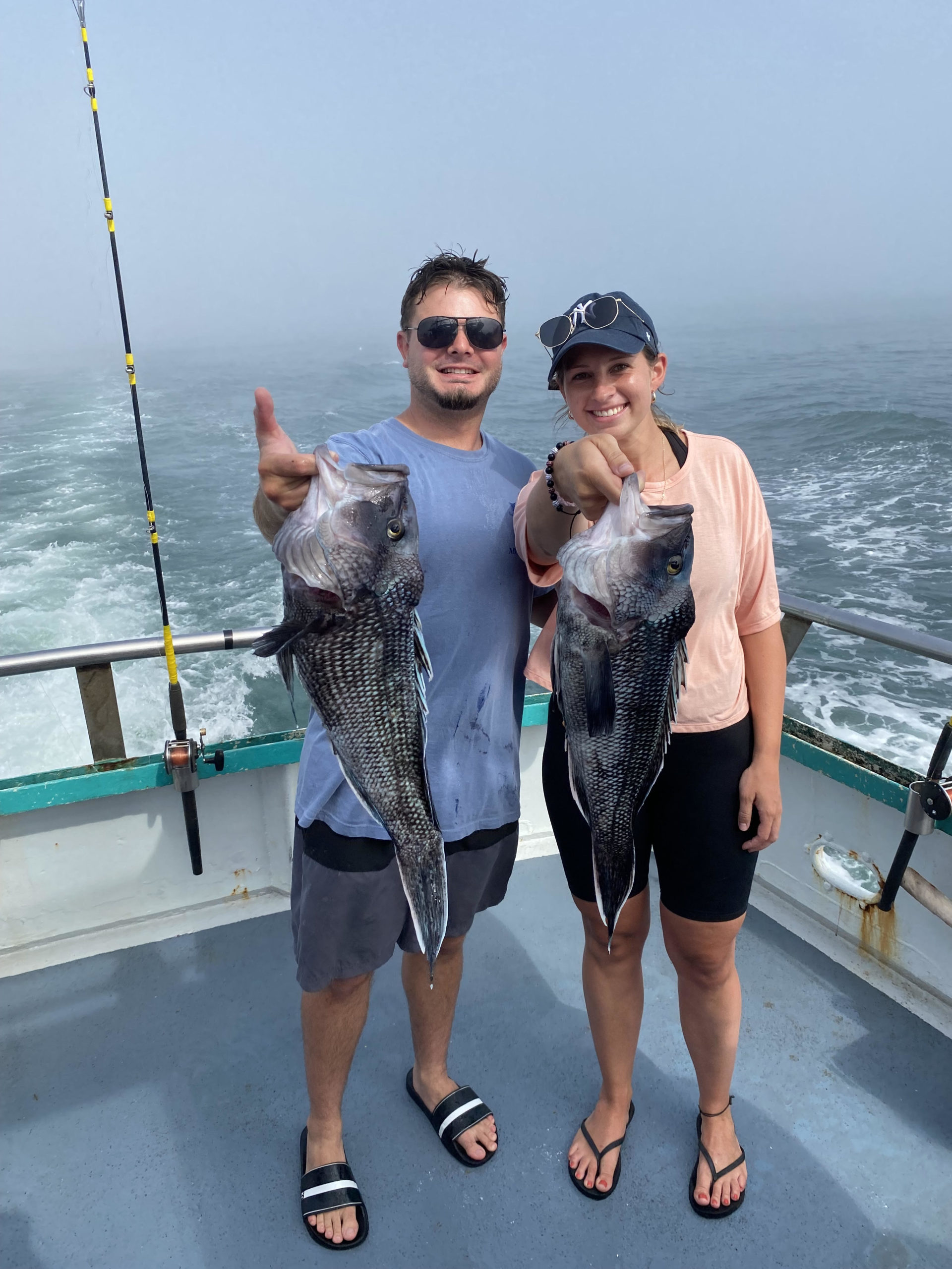a group of people standing next to a body of water