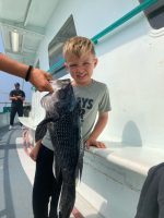 a man holding a fish