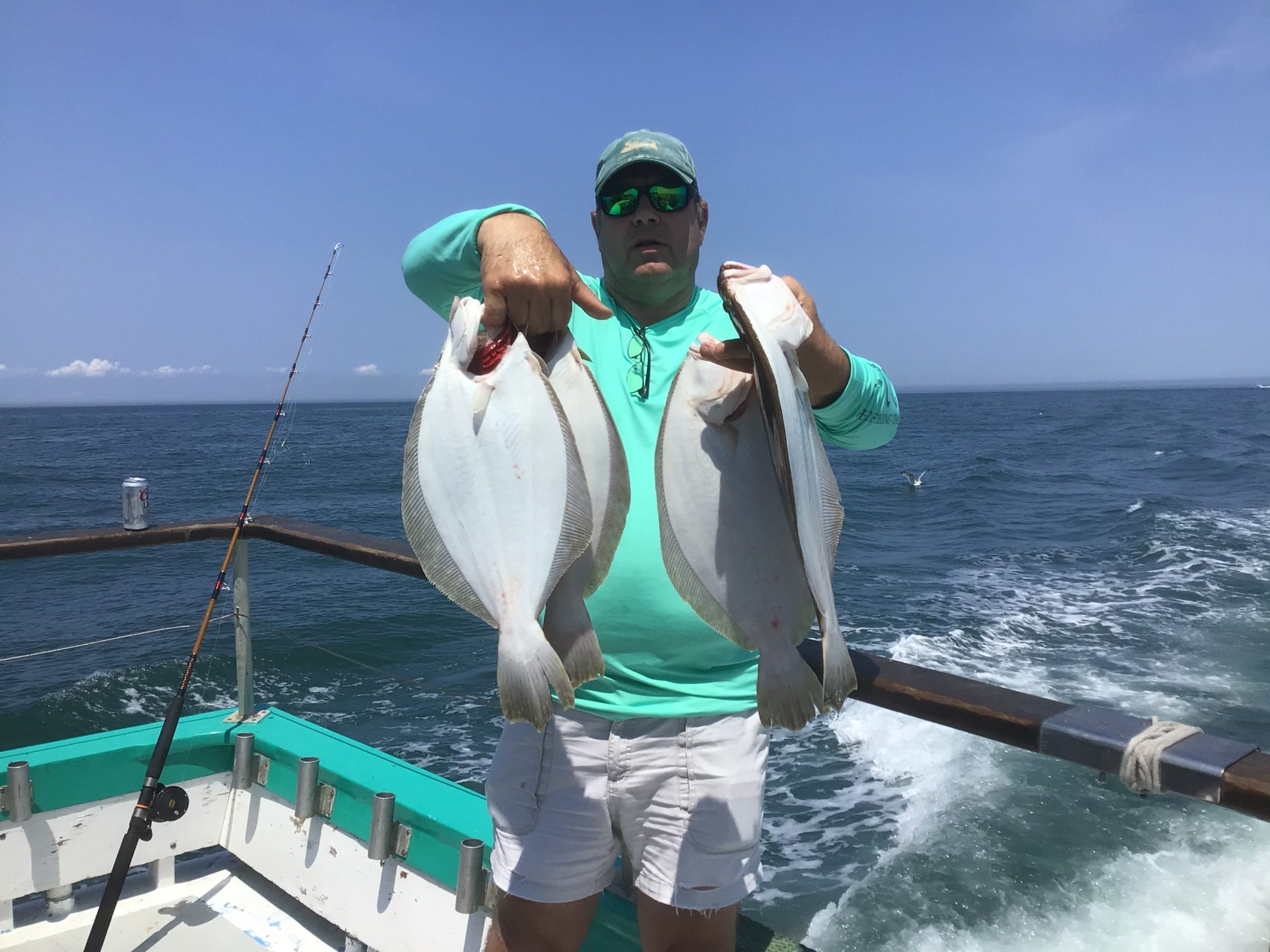 a man standing next to a body of water