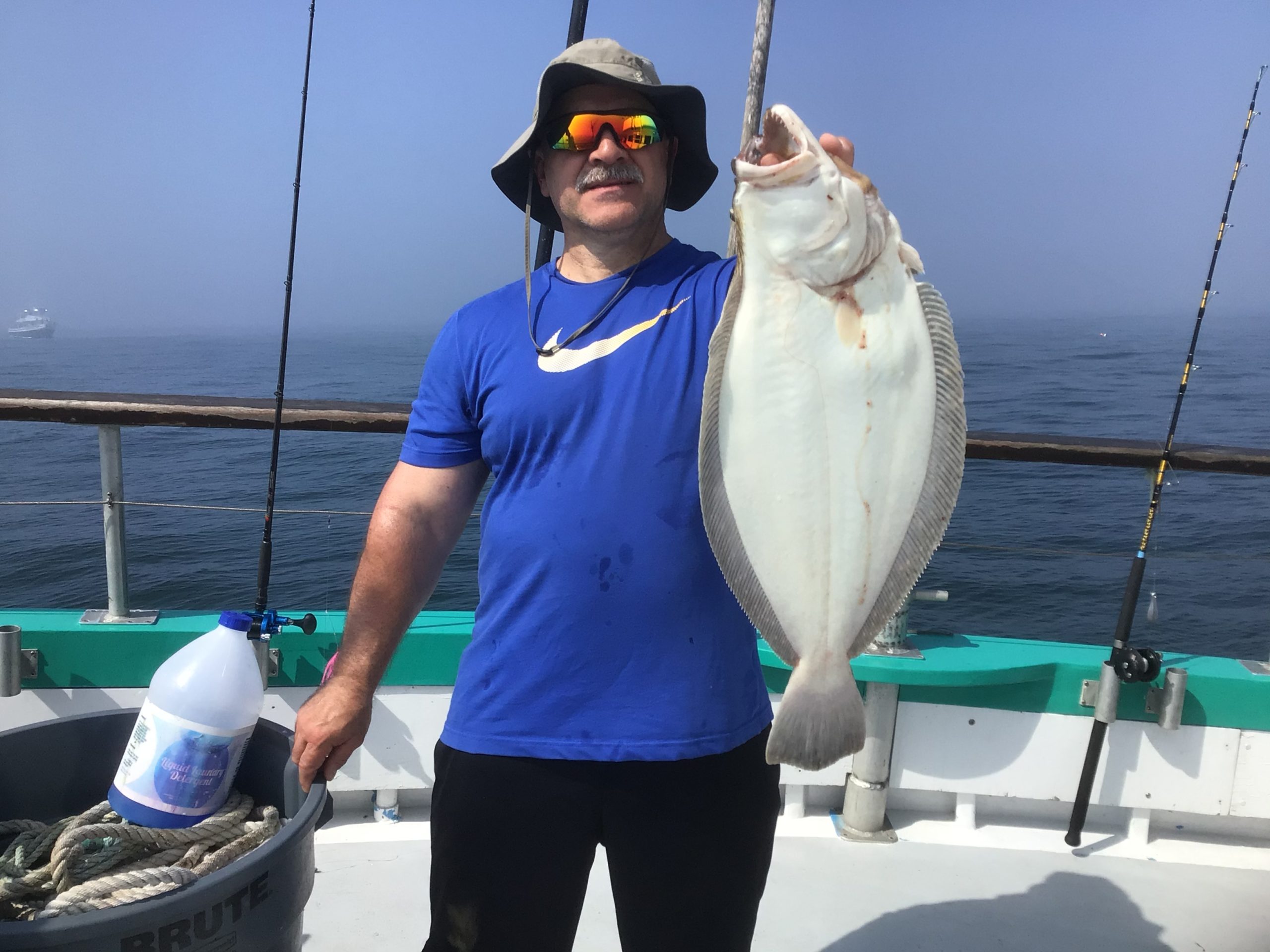 a man holding a fish on a boat
