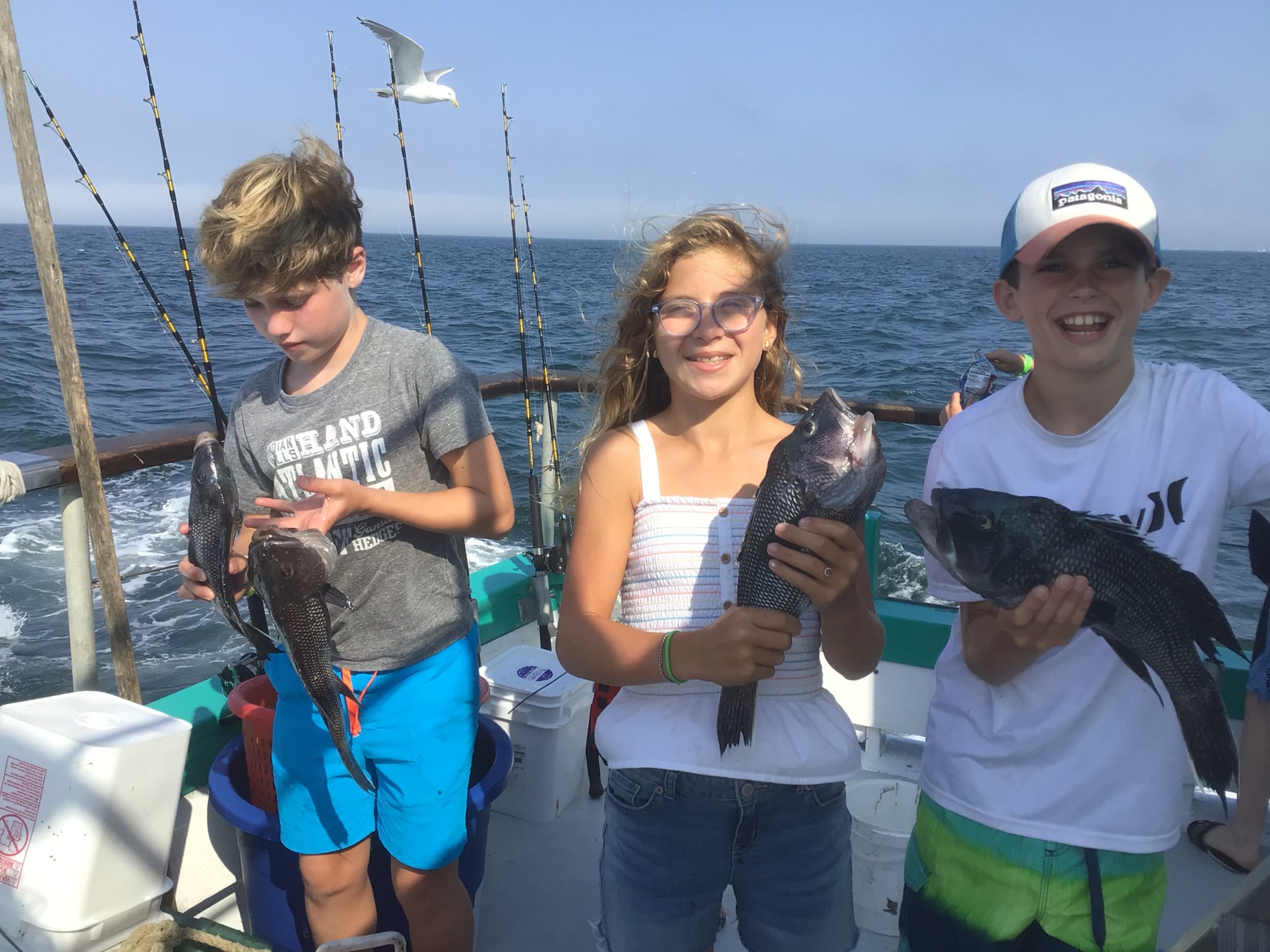 a group of people standing next to a body of water